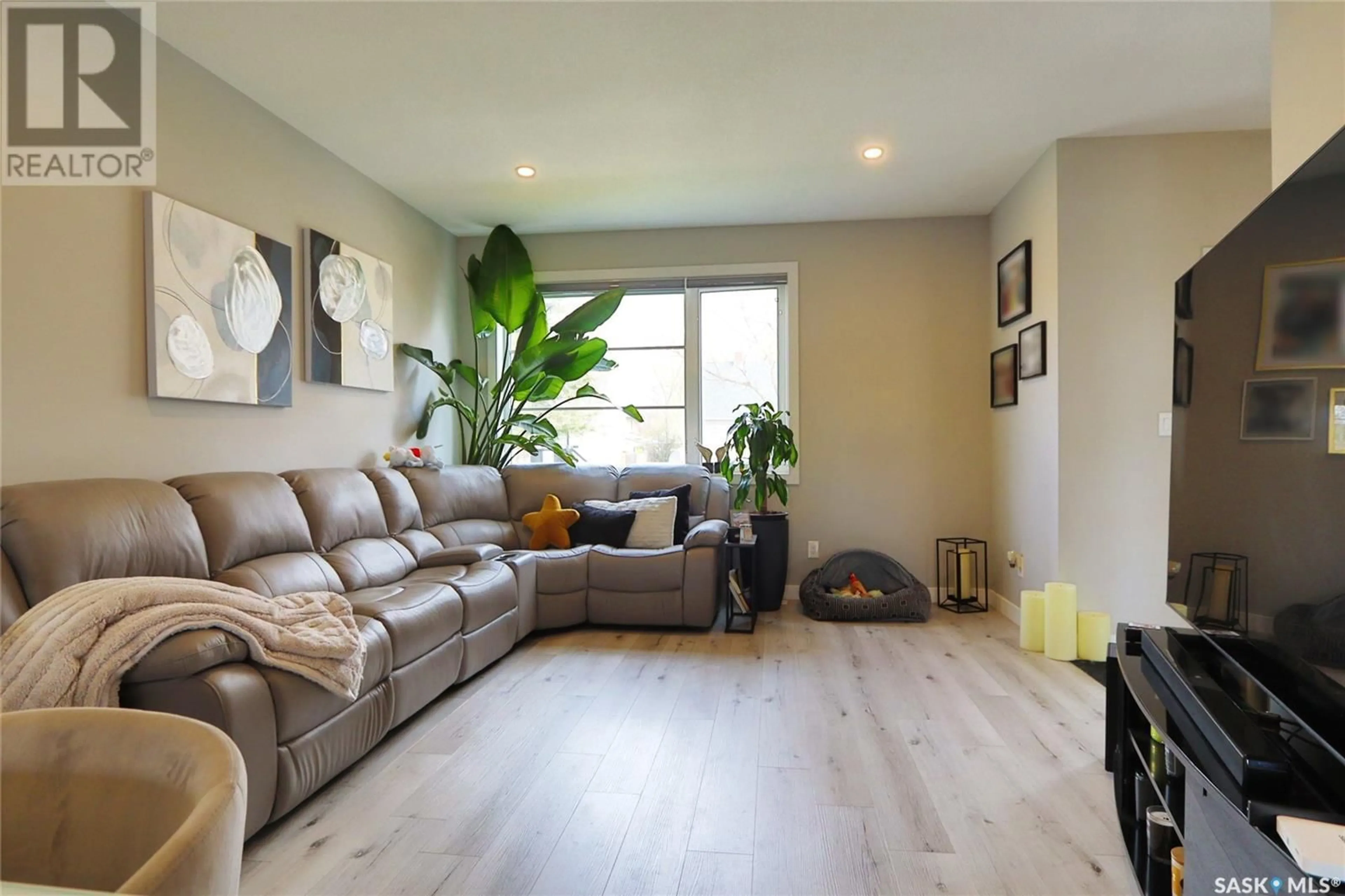 Living room with furniture, wood/laminate floor for 2260 WASCANA STREET, Regina Saskatchewan S4S6Y9