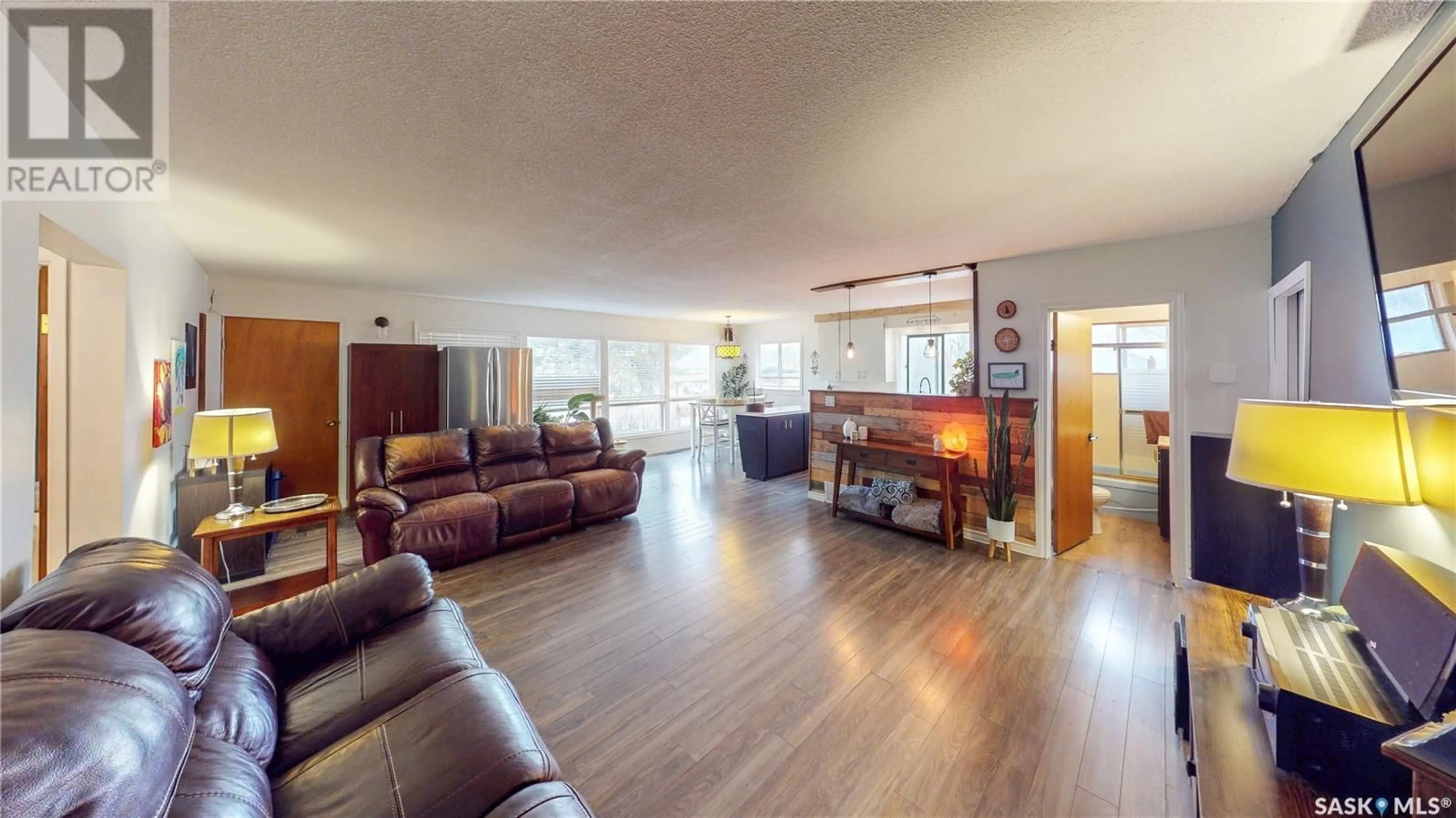Living room with furniture, wood/laminate floor for 236 MACMURCHY AVENUE, Regina Beach Saskatchewan S0G4C0