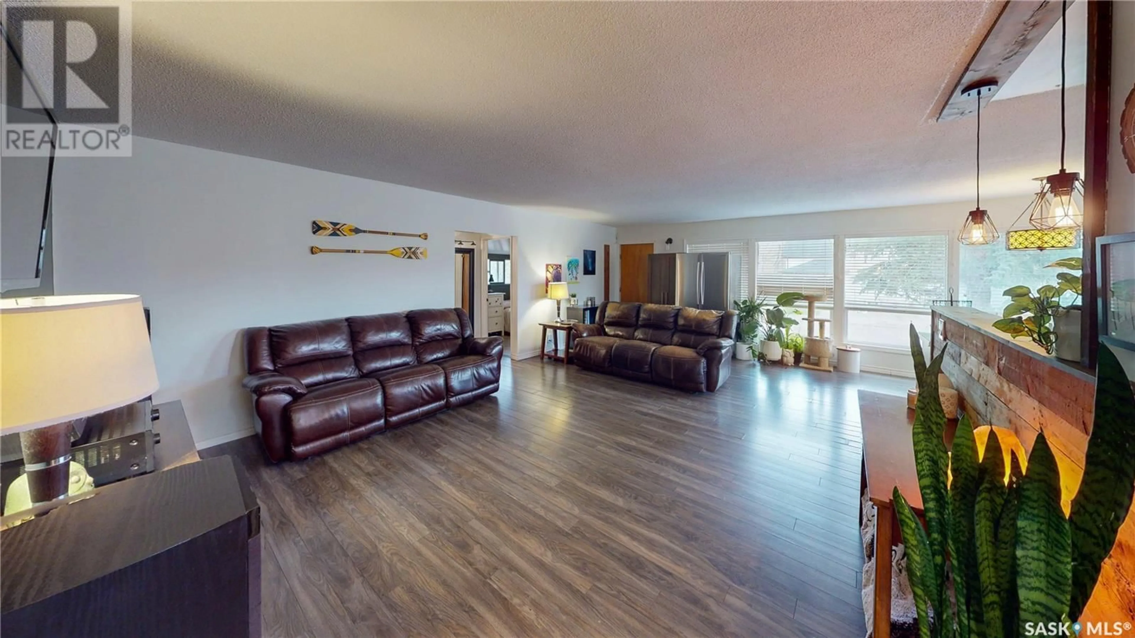 Living room with furniture, wood/laminate floor for 236 MACMURCHY AVENUE, Regina Beach Saskatchewan S0G4C0