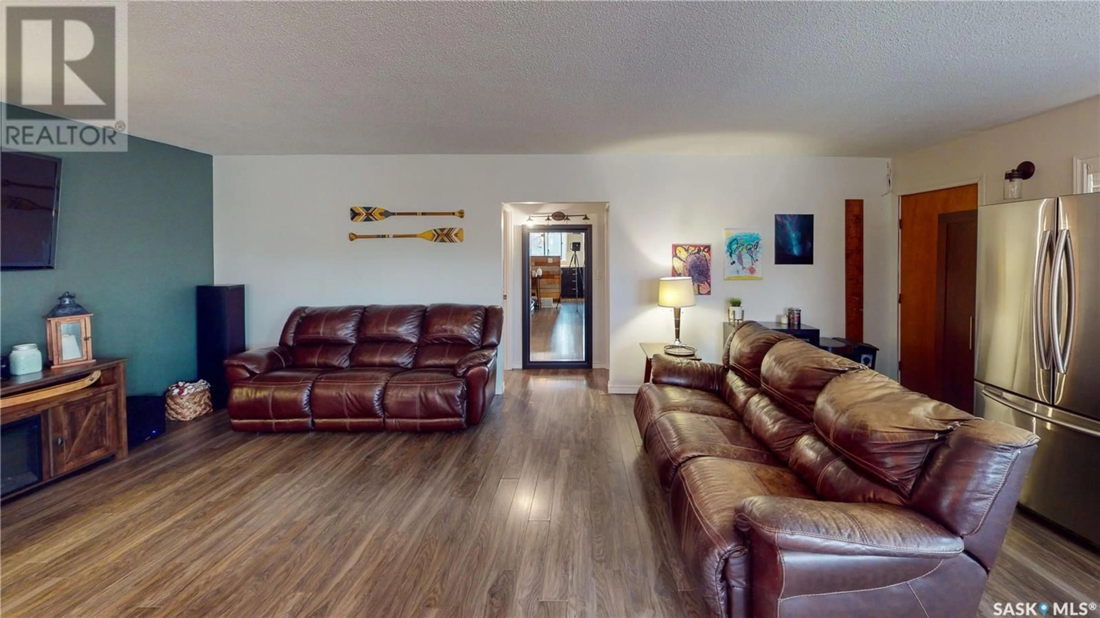 Living room with furniture, wood/laminate floor for 236 MACMURCHY AVENUE, Regina Beach Saskatchewan S0G4C0