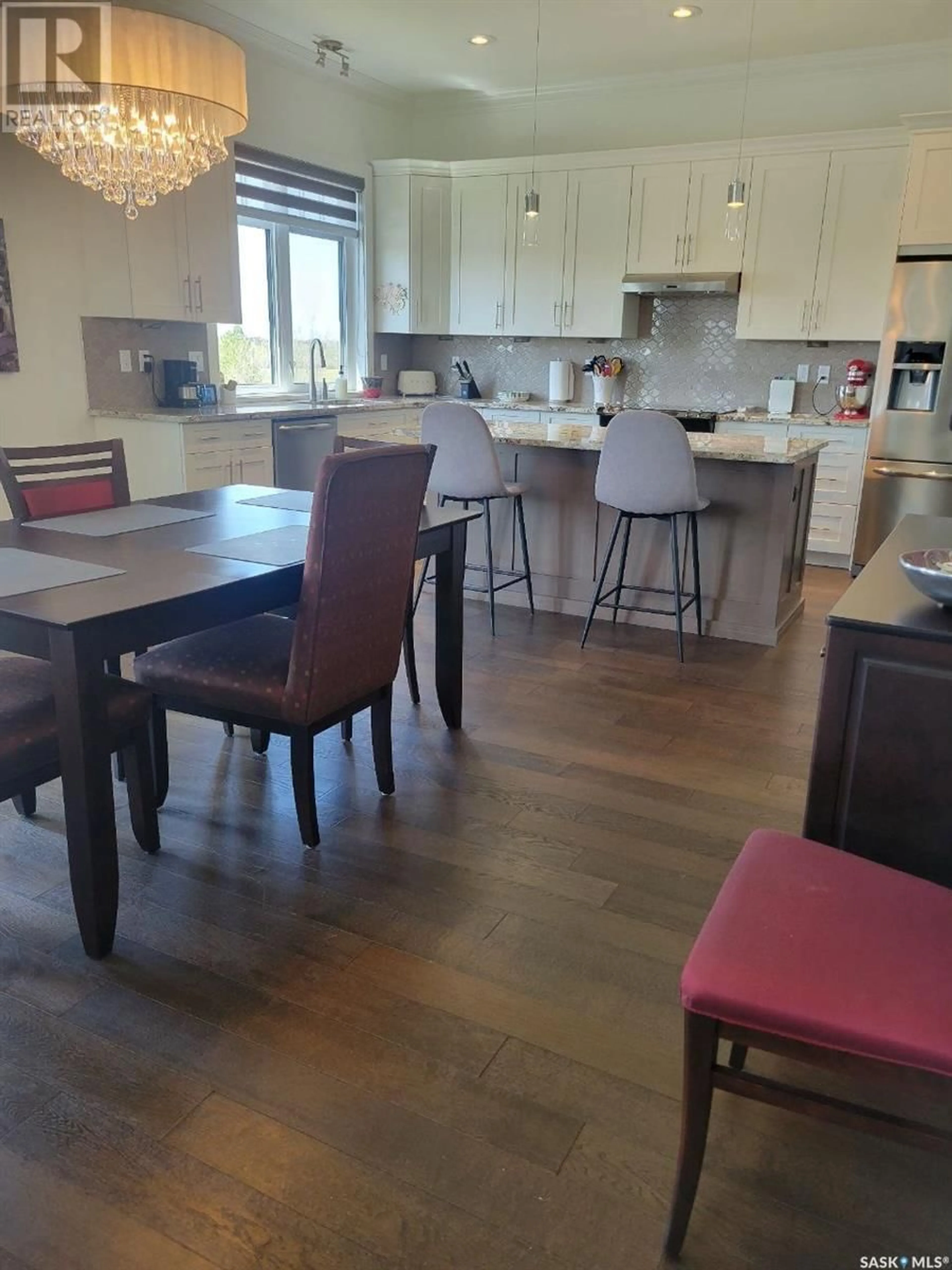 Open concept kitchen, wood/laminate floor for 23 115 MEADOWS BOULEVARD, Saskatoon Saskatchewan S7V0E4