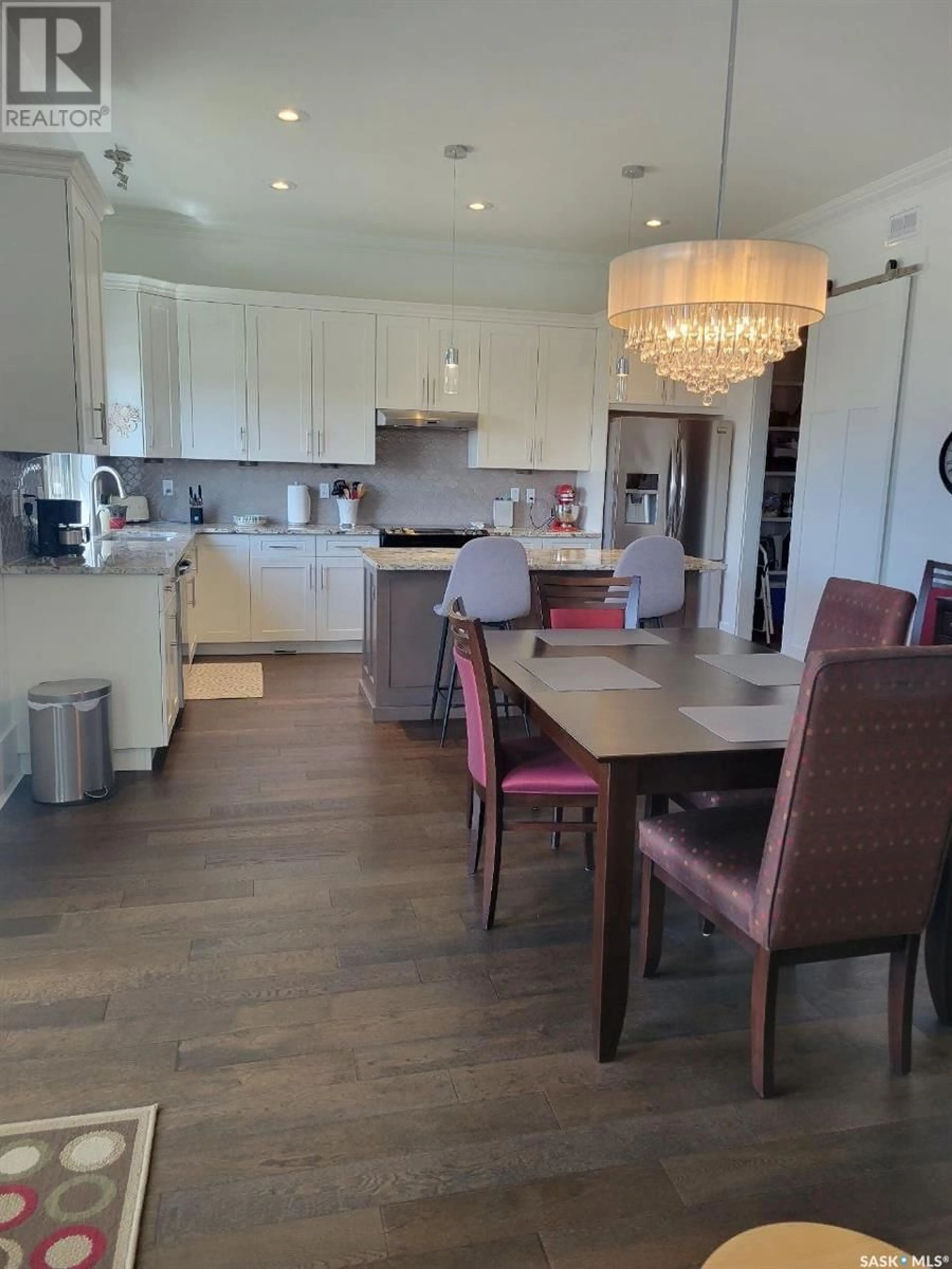 Open concept kitchen, wood/laminate floor for 23 115 MEADOWS BOULEVARD, Saskatoon Saskatchewan S7V0E4