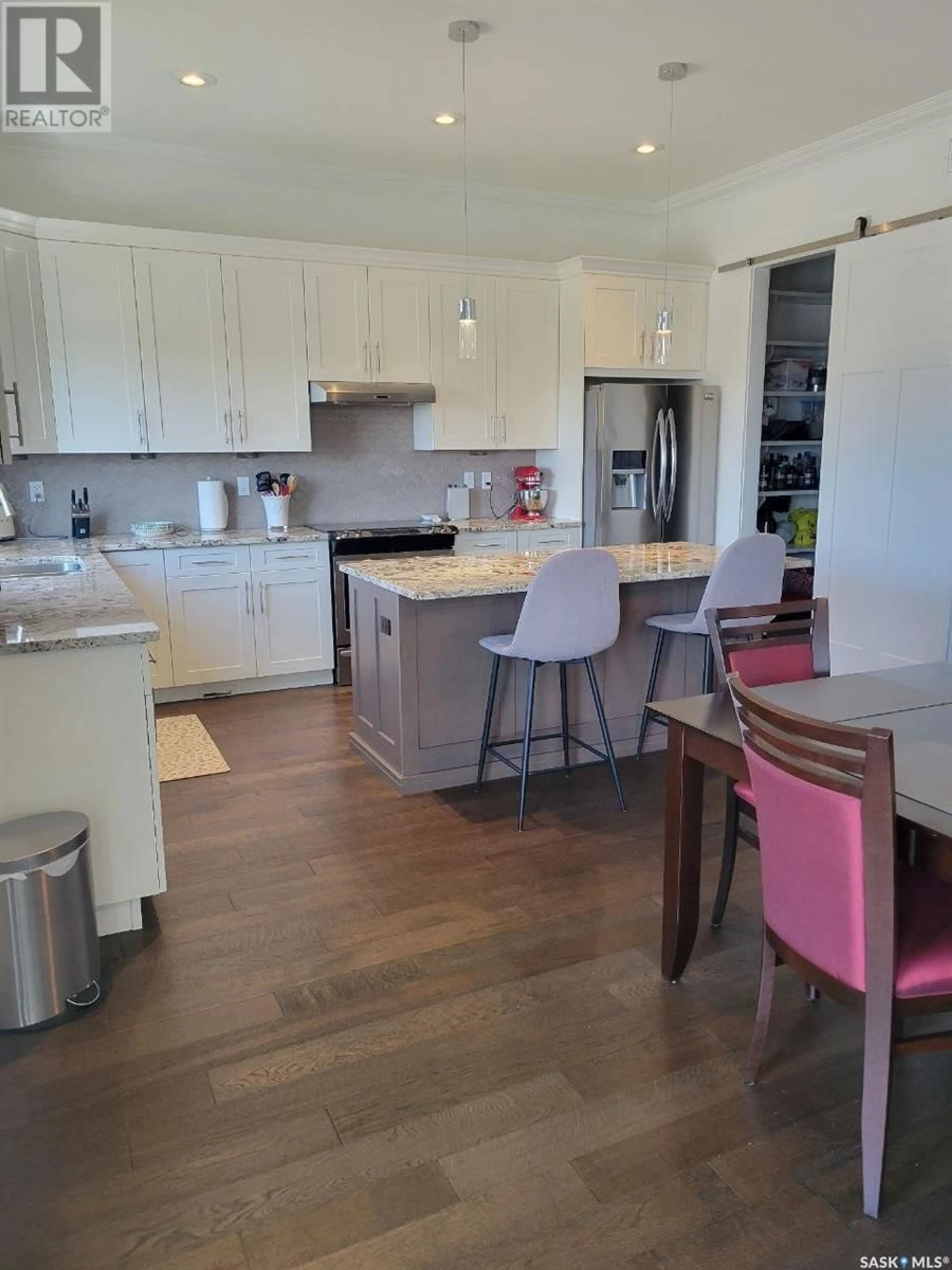 Open concept kitchen, wood/laminate floor for 23 115 MEADOWS BOULEVARD, Saskatoon Saskatchewan S7V0E4