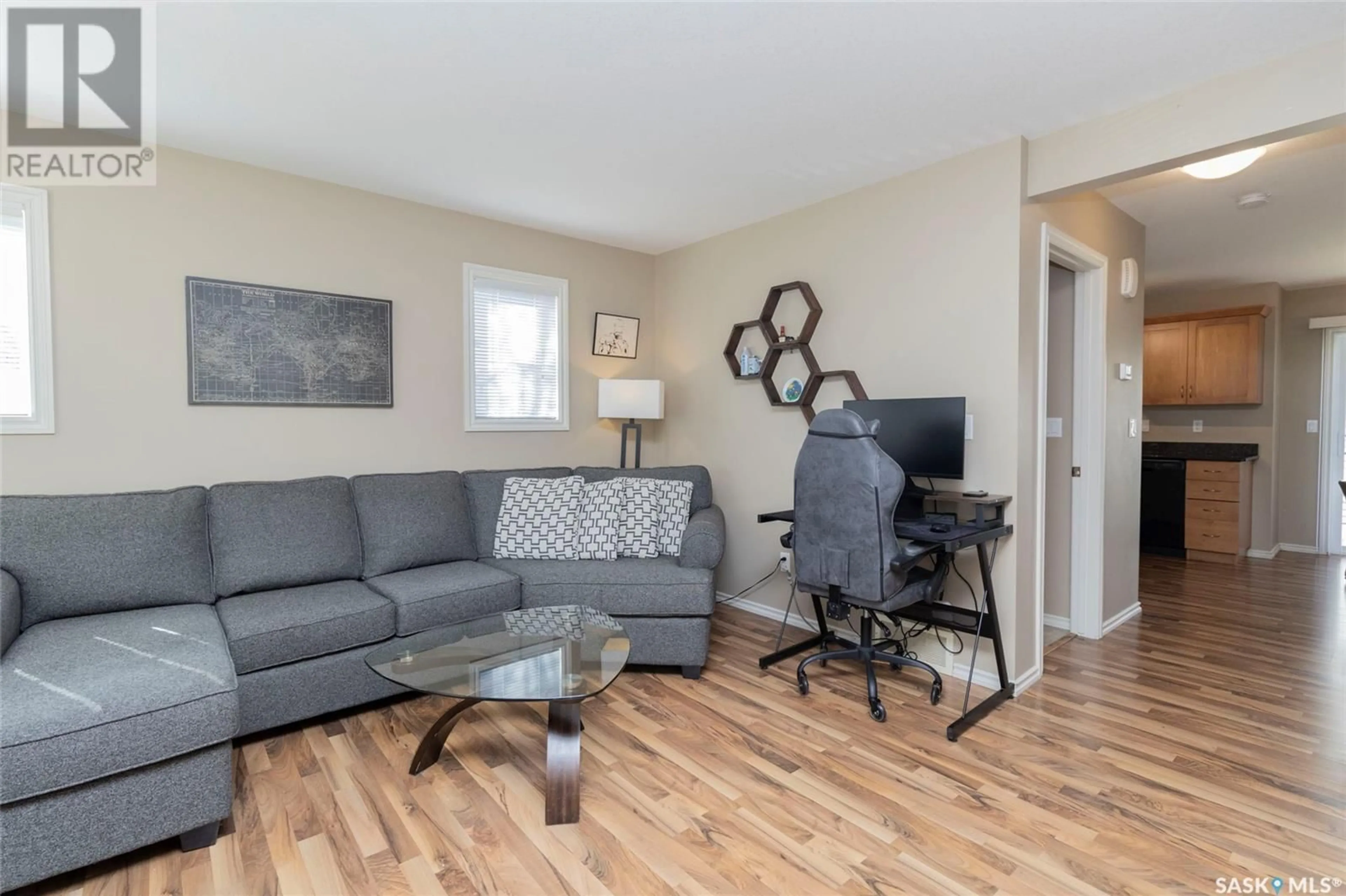 Living room with furniture, wood/laminate floor for 303 - 401 SLIMMON PLACE, Saskatoon Saskatchewan S7V0A8