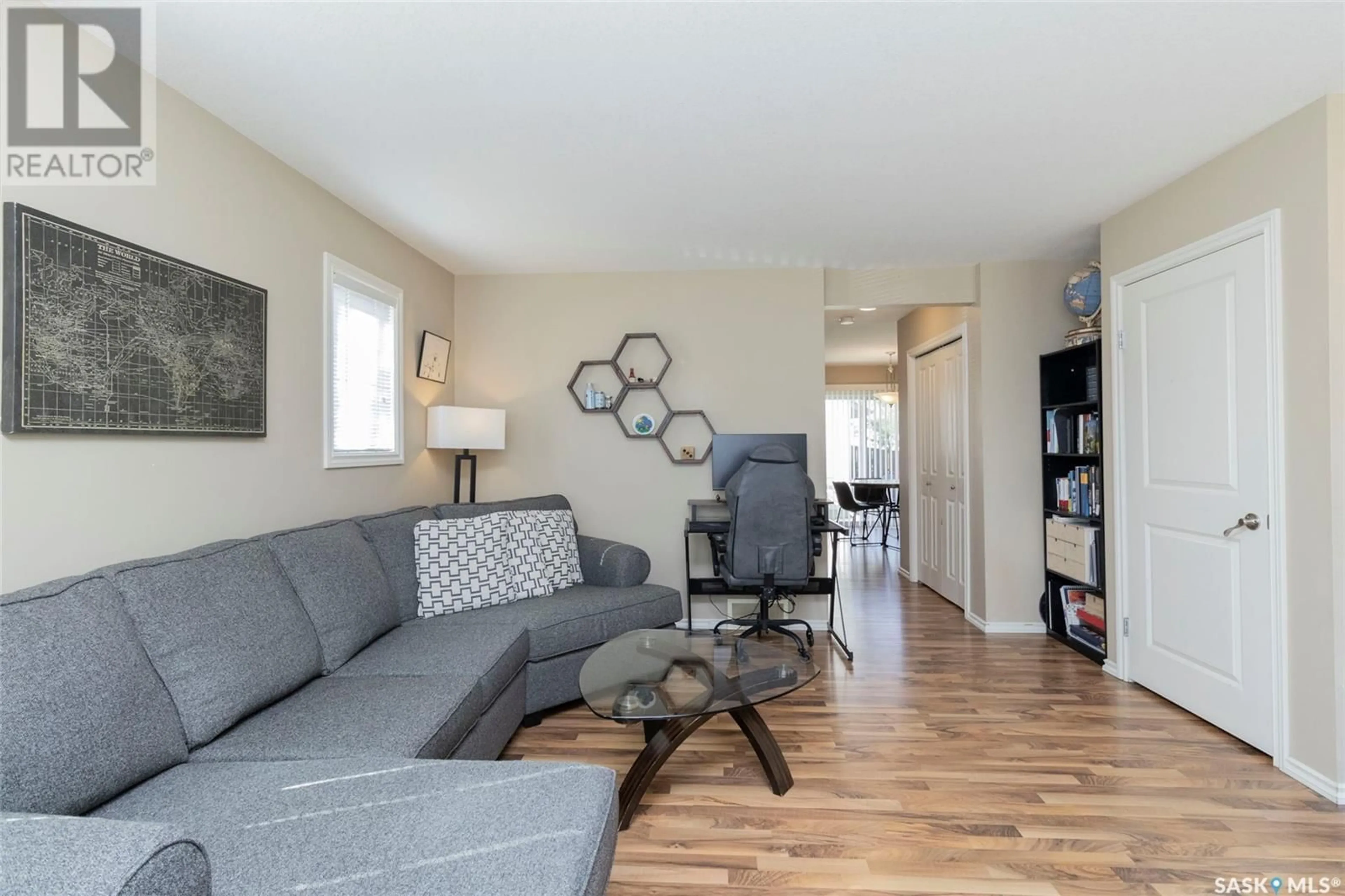 Living room with furniture, wood/laminate floor for 303 - 401 SLIMMON PLACE, Saskatoon Saskatchewan S7V0A8