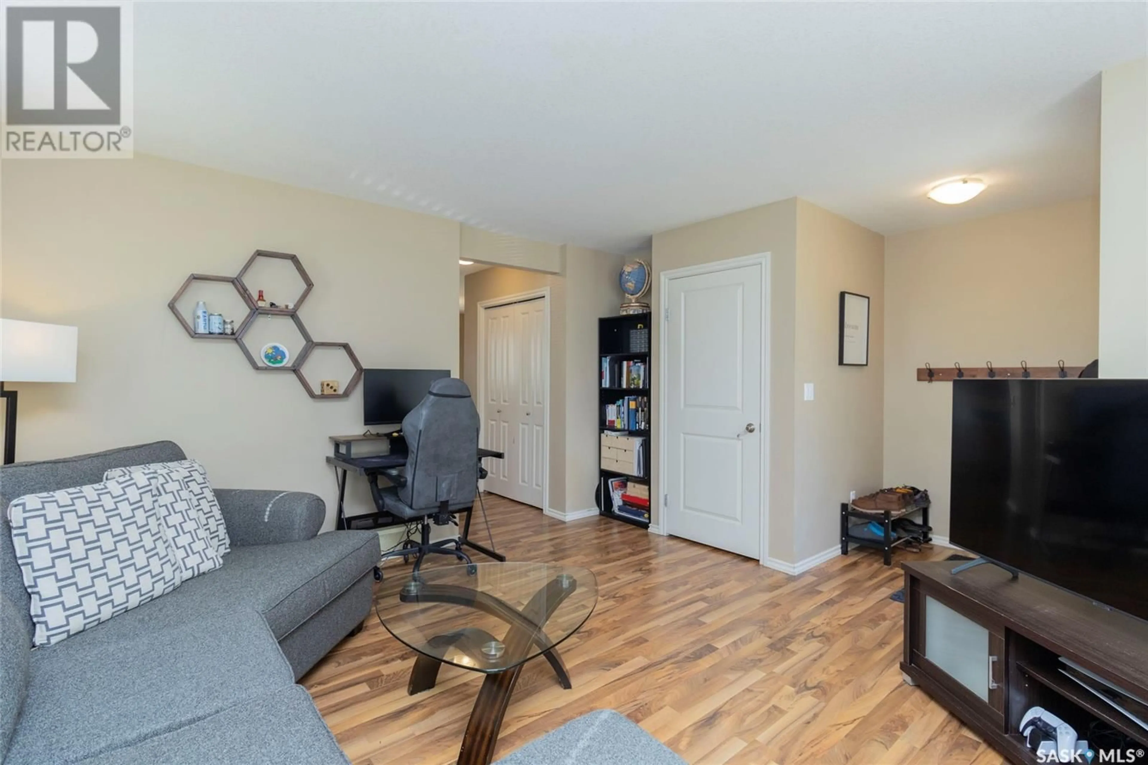 Living room with furniture, wood/laminate floor for 303 - 401 SLIMMON PLACE, Saskatoon Saskatchewan S7V0A8