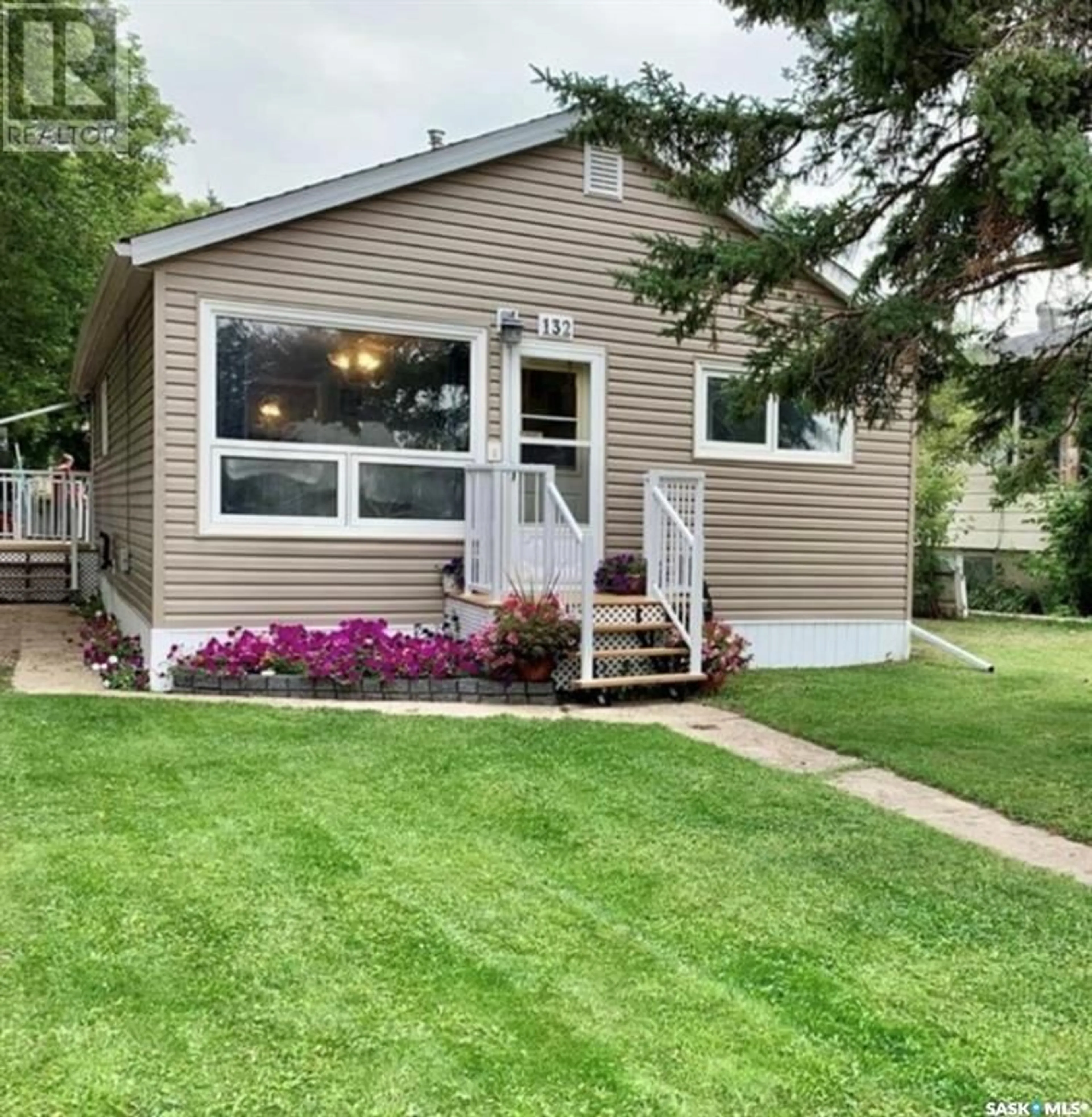Home with vinyl exterior material, street for 132 2ND AVENUE, Swift Current Saskatchewan S9H3H9