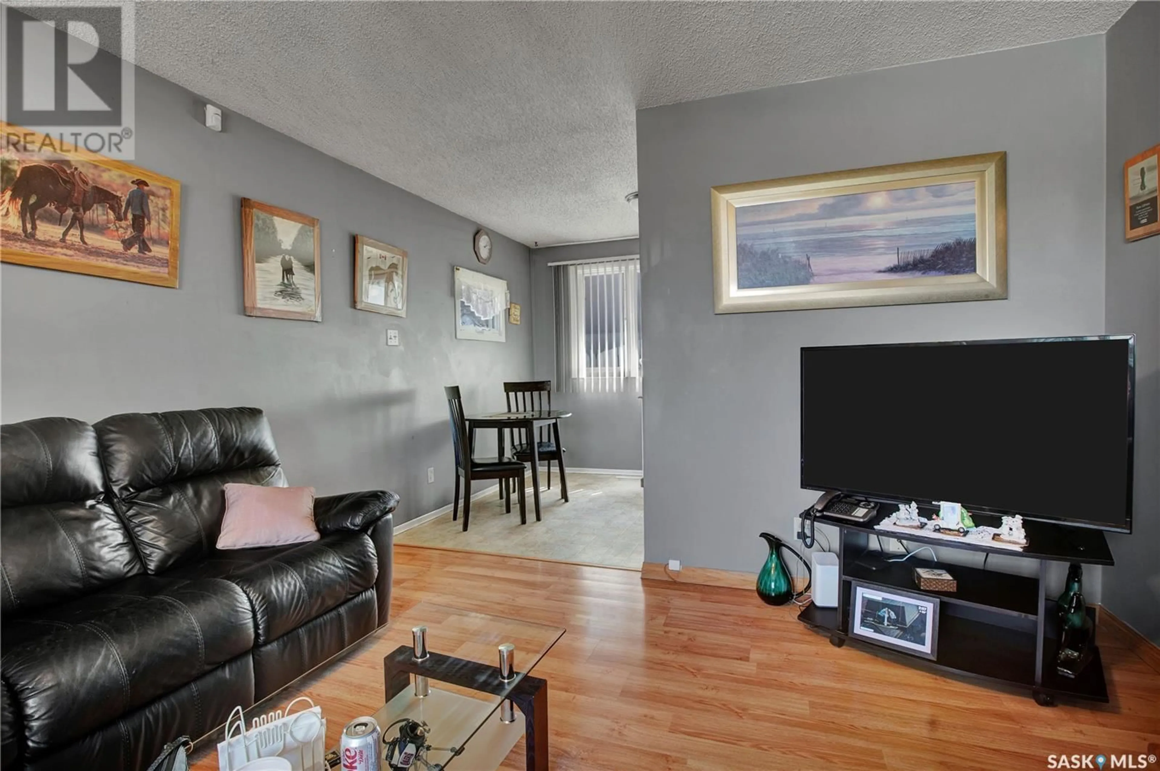 Living room with furniture, wood/laminate floor for 937 R AVENUE N, Saskatoon Saskatchewan S7L2Z4