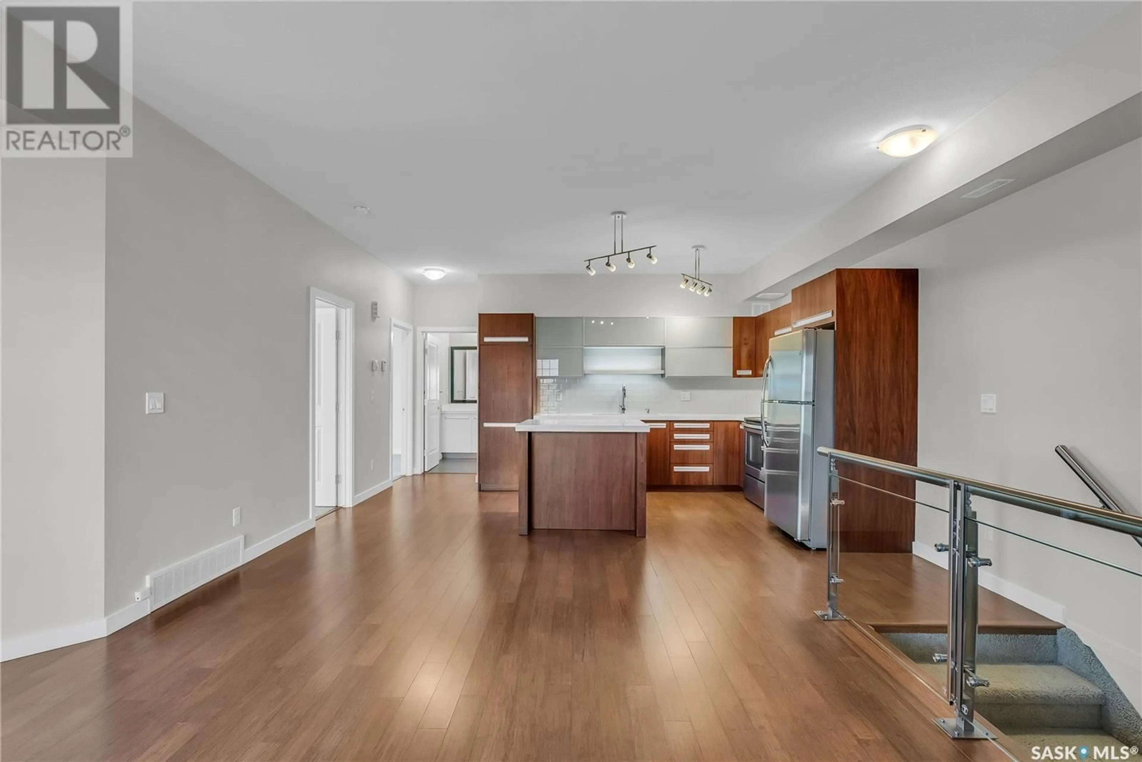 Open concept kitchen, wood/laminate floor for 1015 - 1908 PATRICK CRESCENT, Saskatoon Saskatchewan S7W0M1