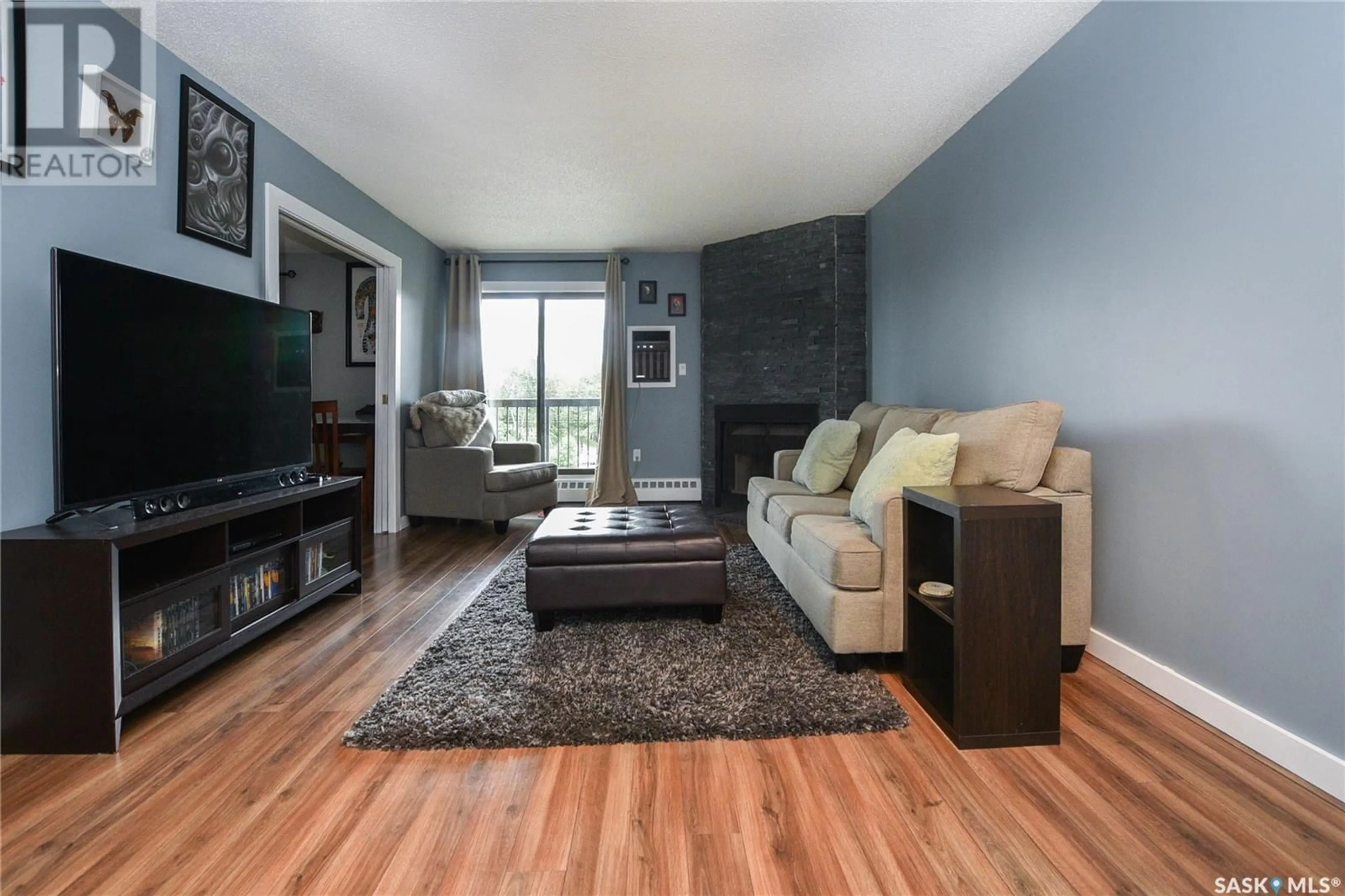 Living room with furniture, wood/laminate floor for 304 - 3410 PARK STREET, Regina Saskatchewan S4V2M8