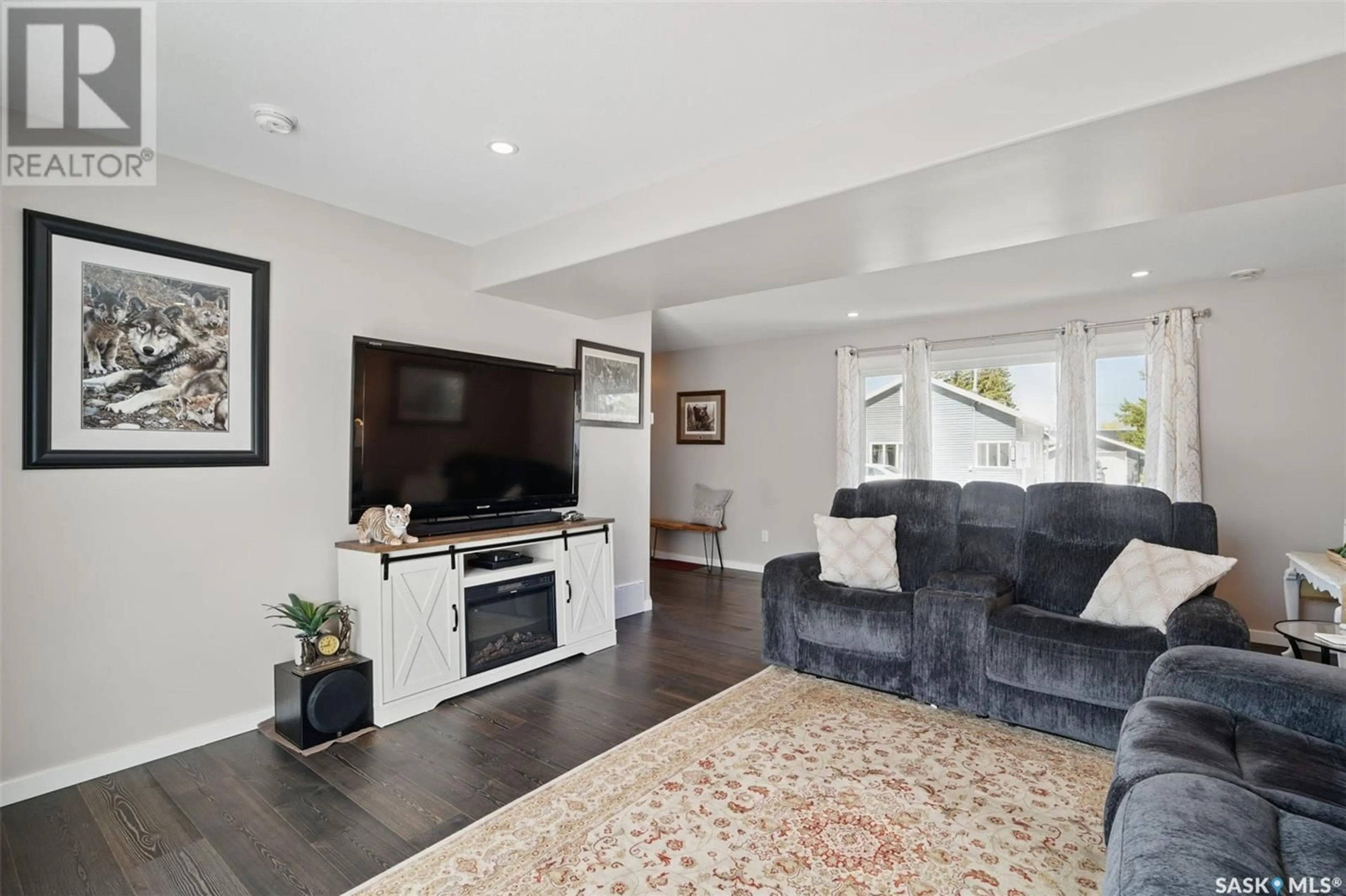 Living room with furniture, wood/laminate floor for 495 CECIL STREET, Asquith Saskatchewan S0K0J0
