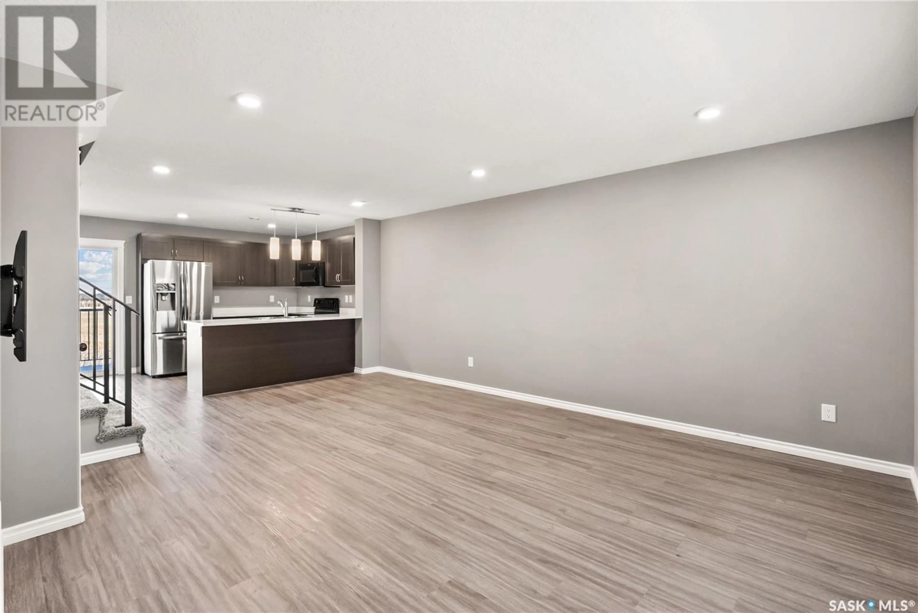 Open concept kitchen, wood/laminate floor for 311 110 AKHTAR BEND, Saskatoon Saskatchewan S7W0Y9