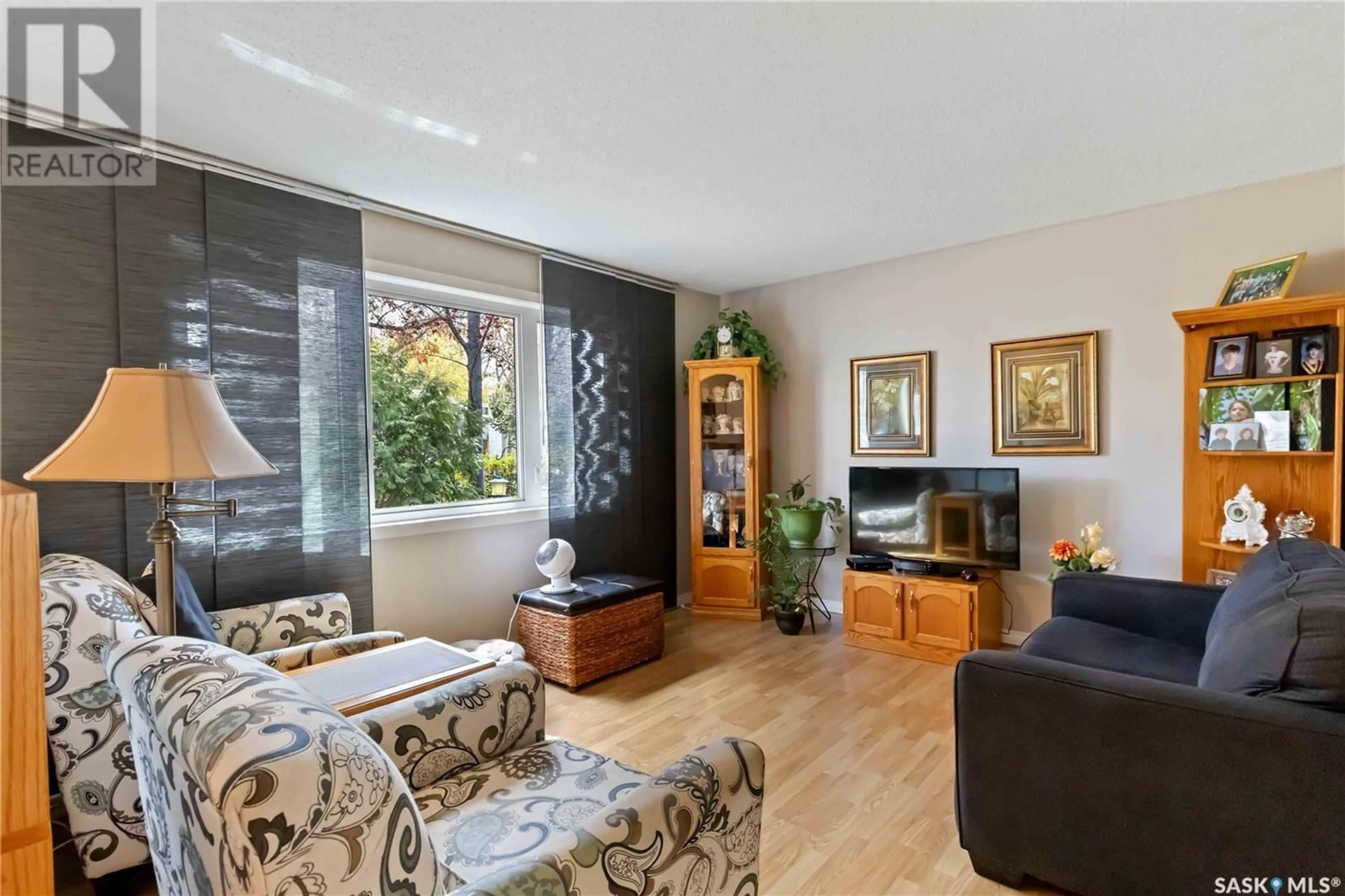 Living room with furniture, wood/laminate floor for 1045 MAHONEY AVENUE, Saskatoon Saskatchewan S7L3Z2