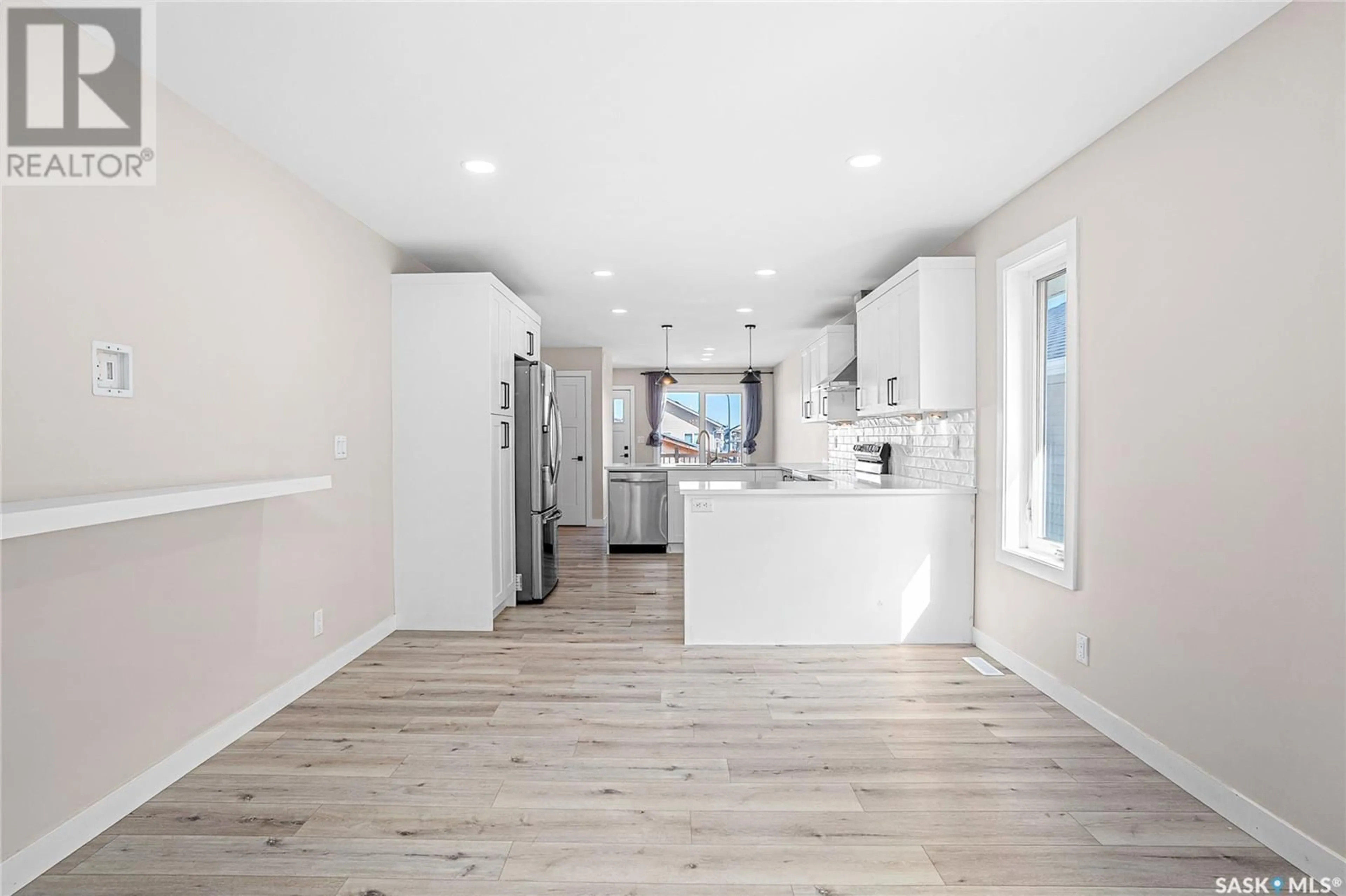 Open concept kitchen, wood/laminate floor for 442 BENTLEY COURT, Saskatoon Saskatchewan S7L6L3