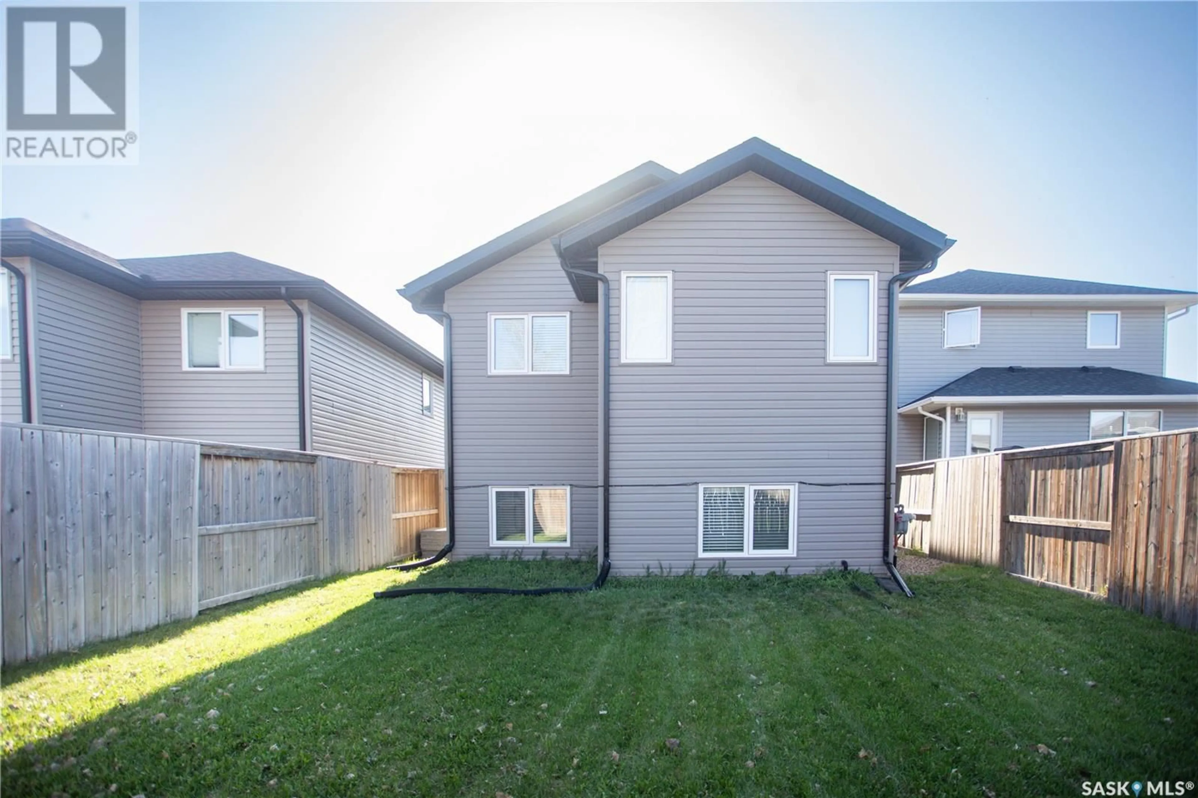 Home with vinyl exterior material, street for 306 HENICK LANE, Saskatoon Saskatchewan S7R0J5