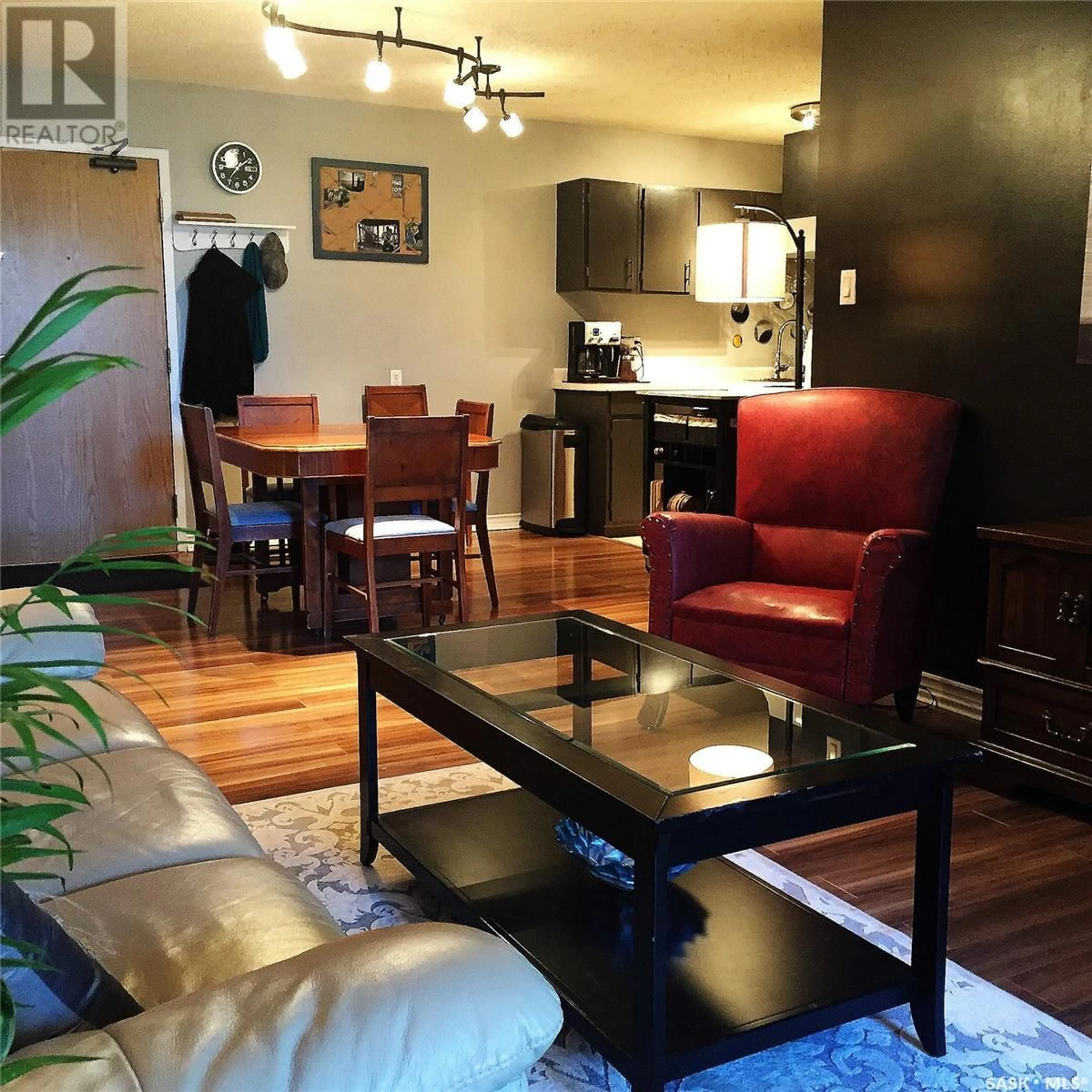 Living room with furniture, wood/laminate floor for 309 311 TAIT CRESCENT, Saskatoon Saskatchewan S7H5L6