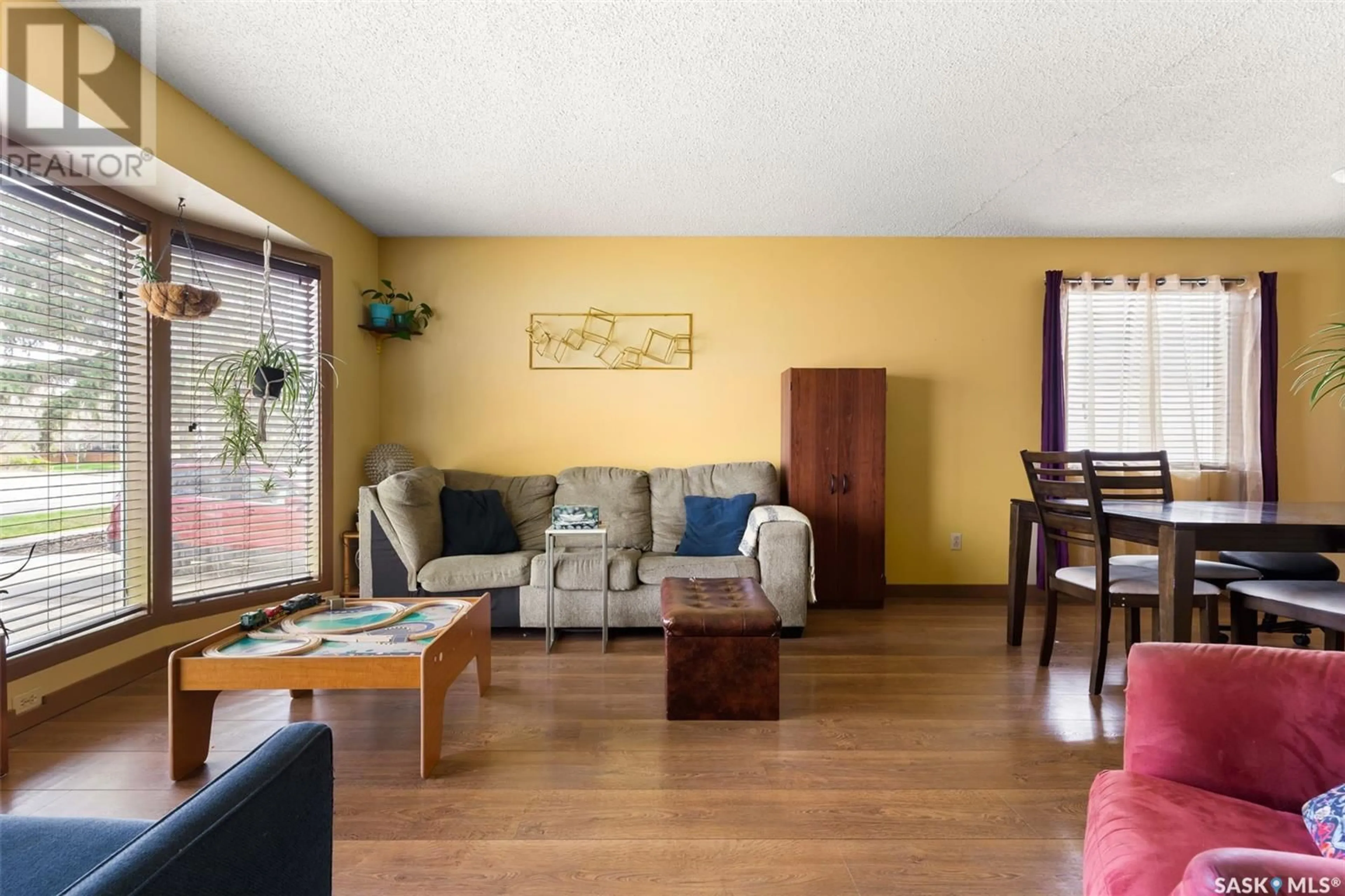 Living room with furniture, wood/laminate floor for 3308 GRANT ROAD, Regina Saskatchewan S4S5H5