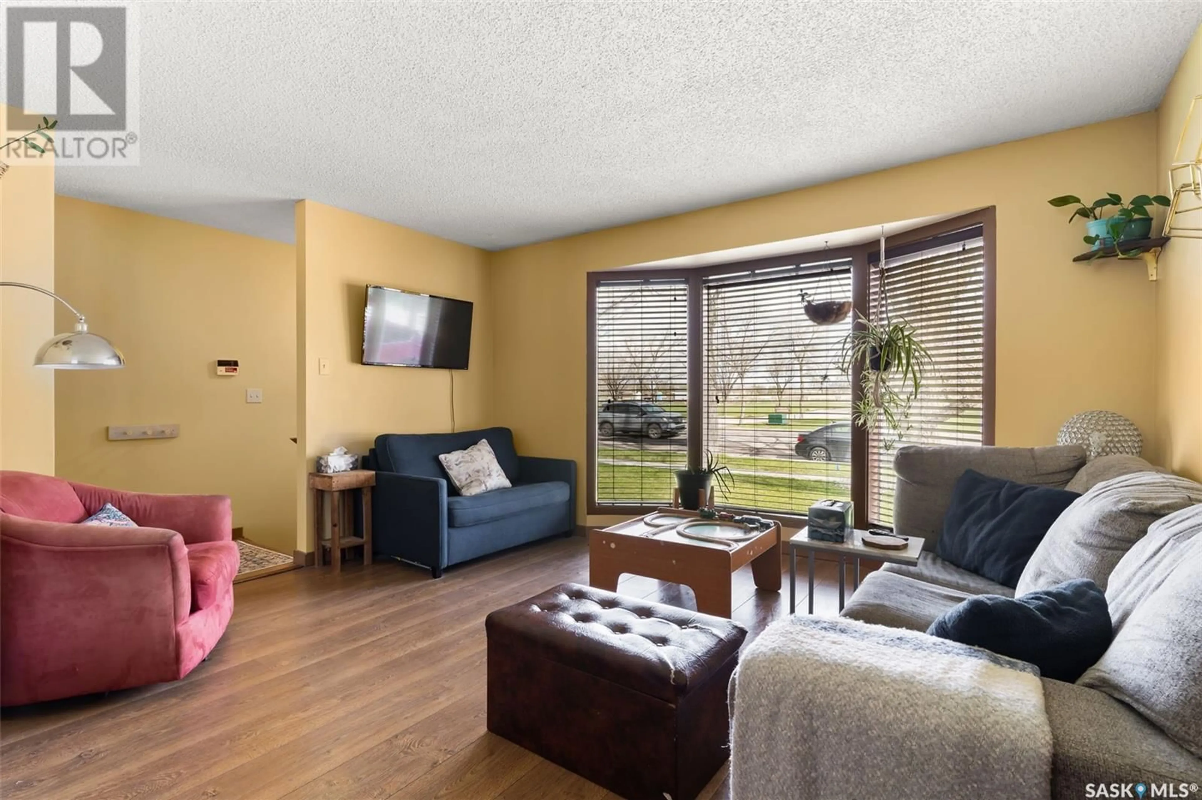 Living room with furniture, wood/laminate floor for 3308 GRANT ROAD, Regina Saskatchewan S4S5H5