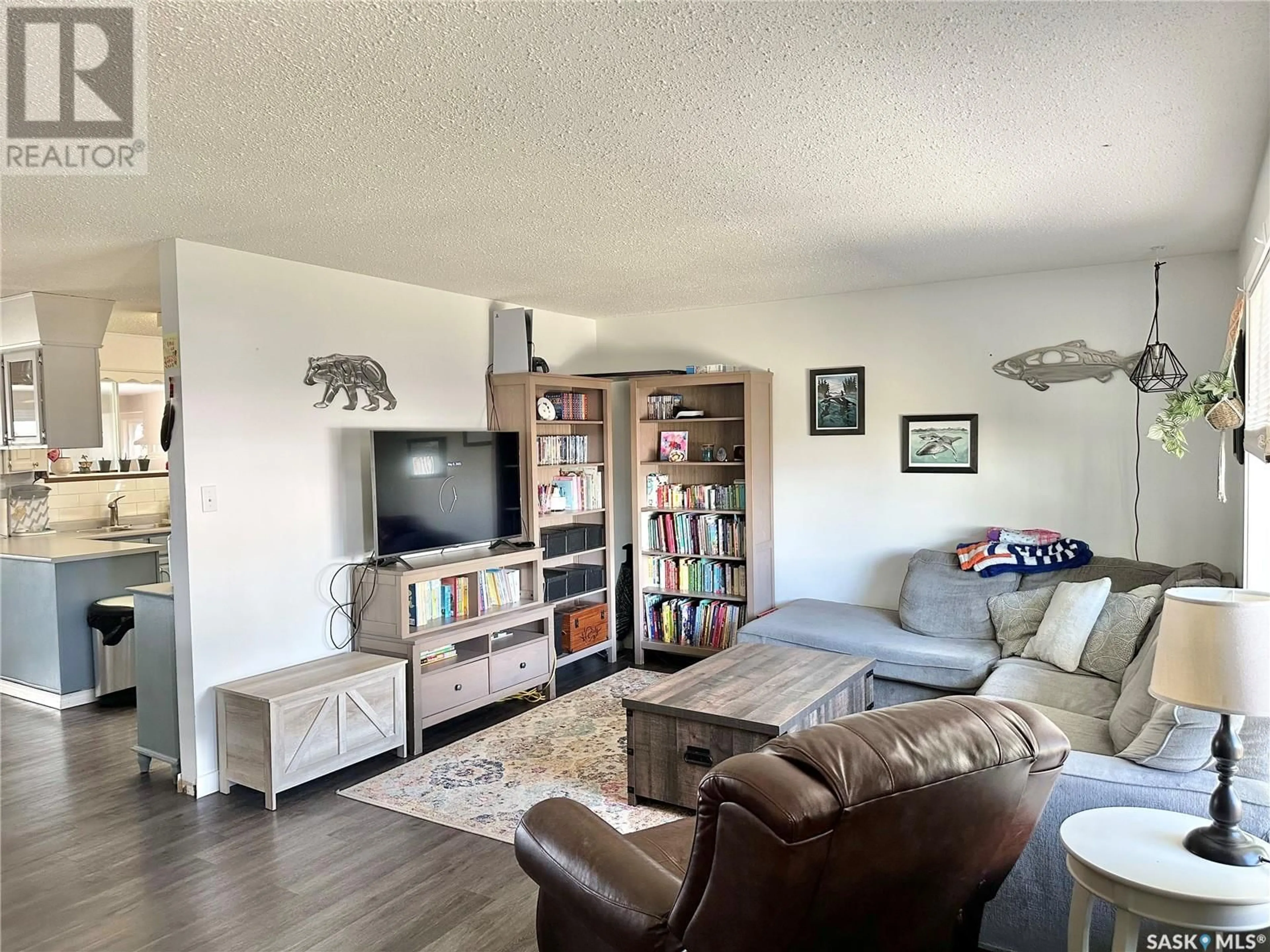 Living room with furniture, wood/laminate floor for 121 FIRST STREET, Spiritwood Saskatchewan S0J2M0