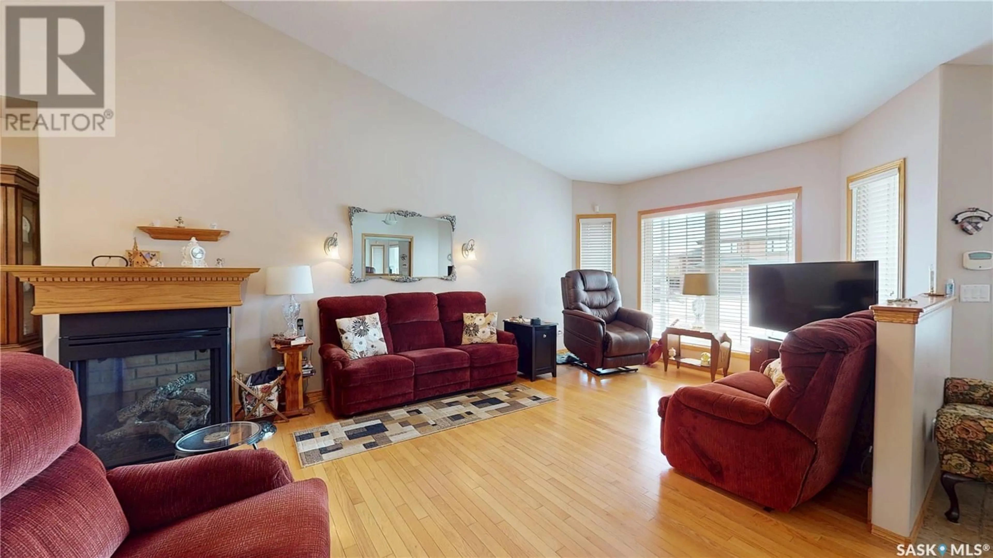 Living room with furniture, wood/laminate floor for 1934 DUNNISON CRESCENT, Regina Saskatchewan S4V0N8