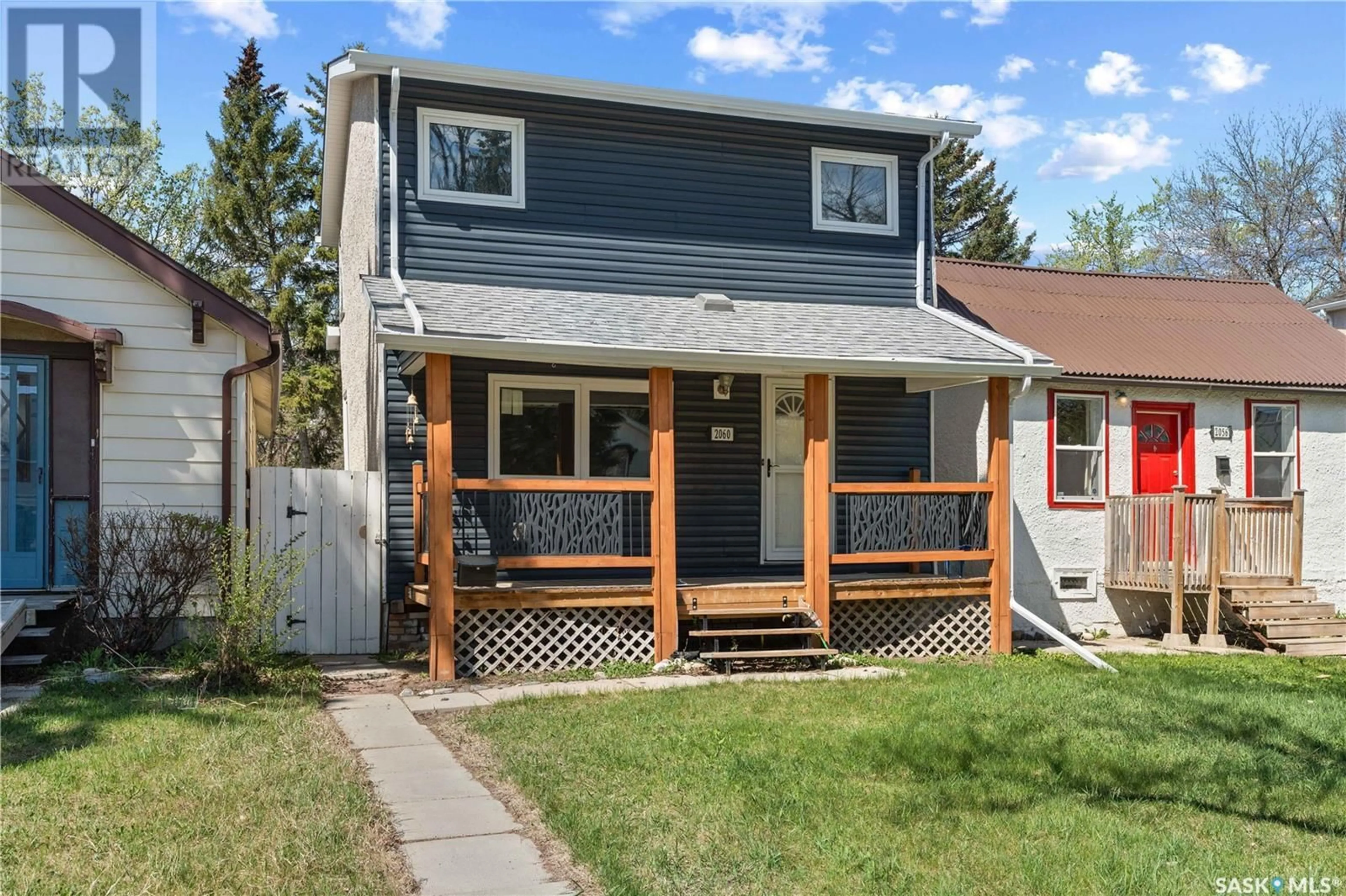 Home with vinyl exterior material, street for 2060 QUEEN STREET, Regina Saskatchewan S4T4C1