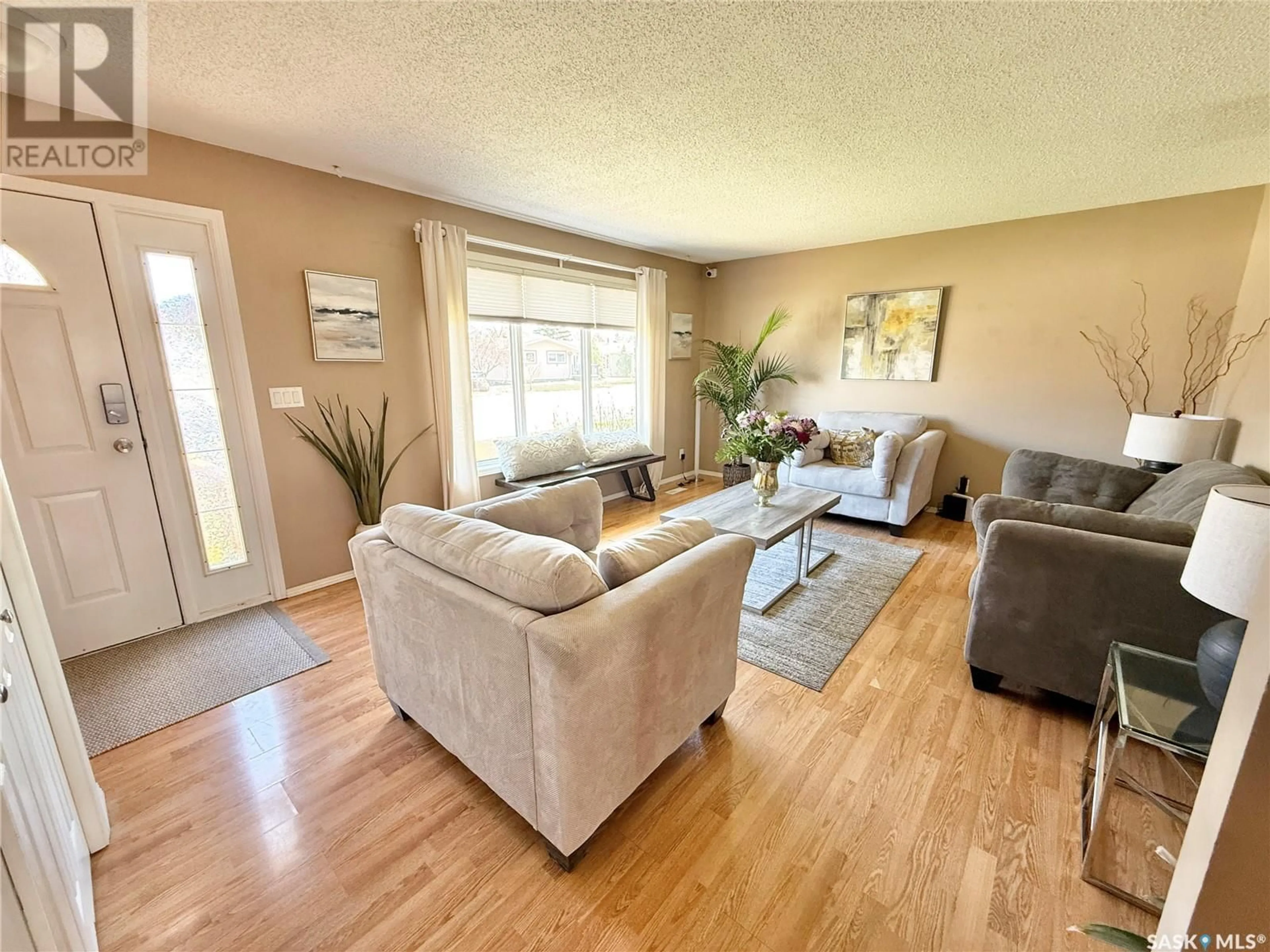 Living room with furniture, wood/laminate floor for 583 13TH STREET, Weyburn Saskatchewan S4H2Y4