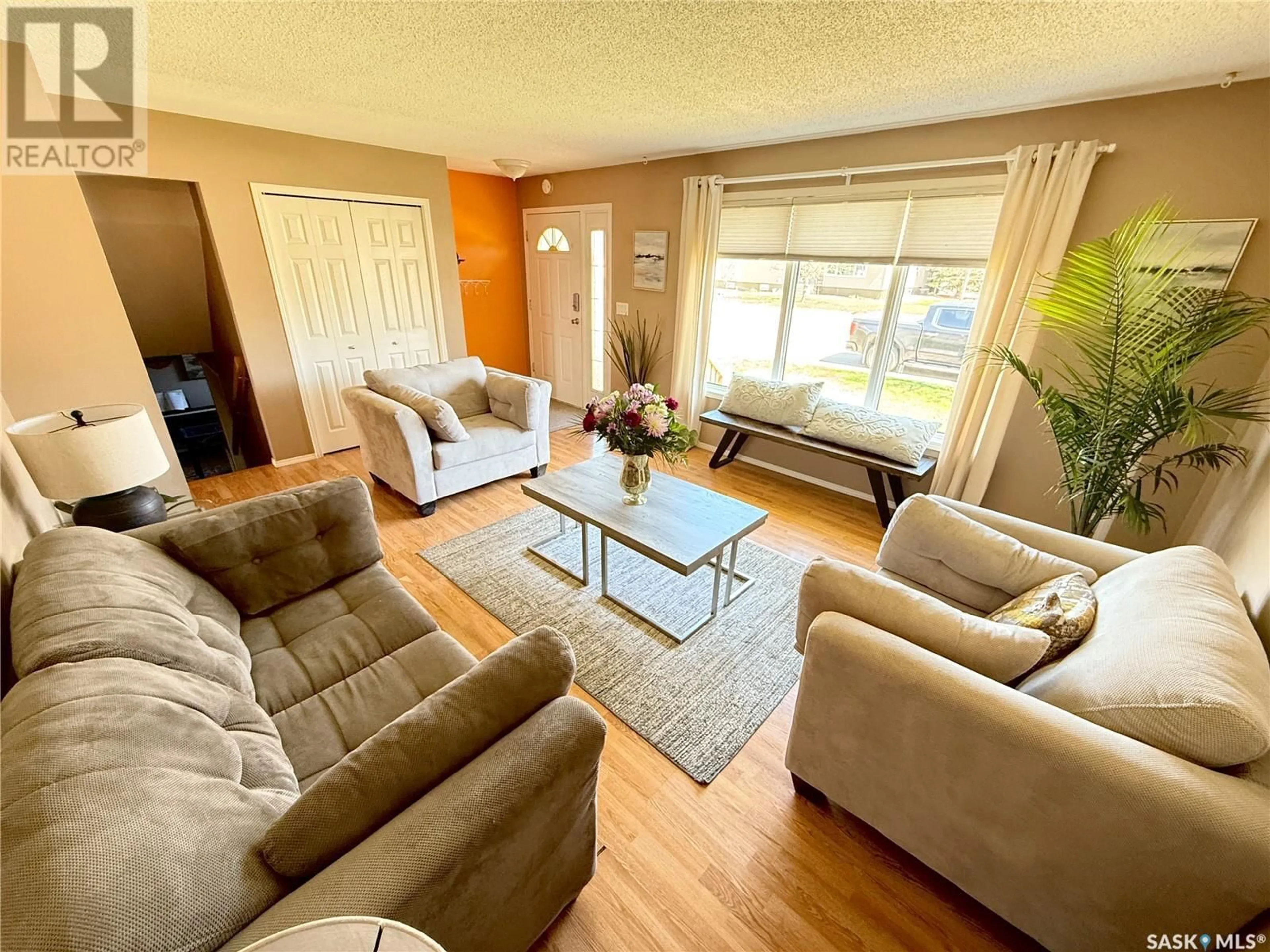 Living room with furniture, wood/laminate floor for 583 13TH STREET, Weyburn Saskatchewan S4H2Y4