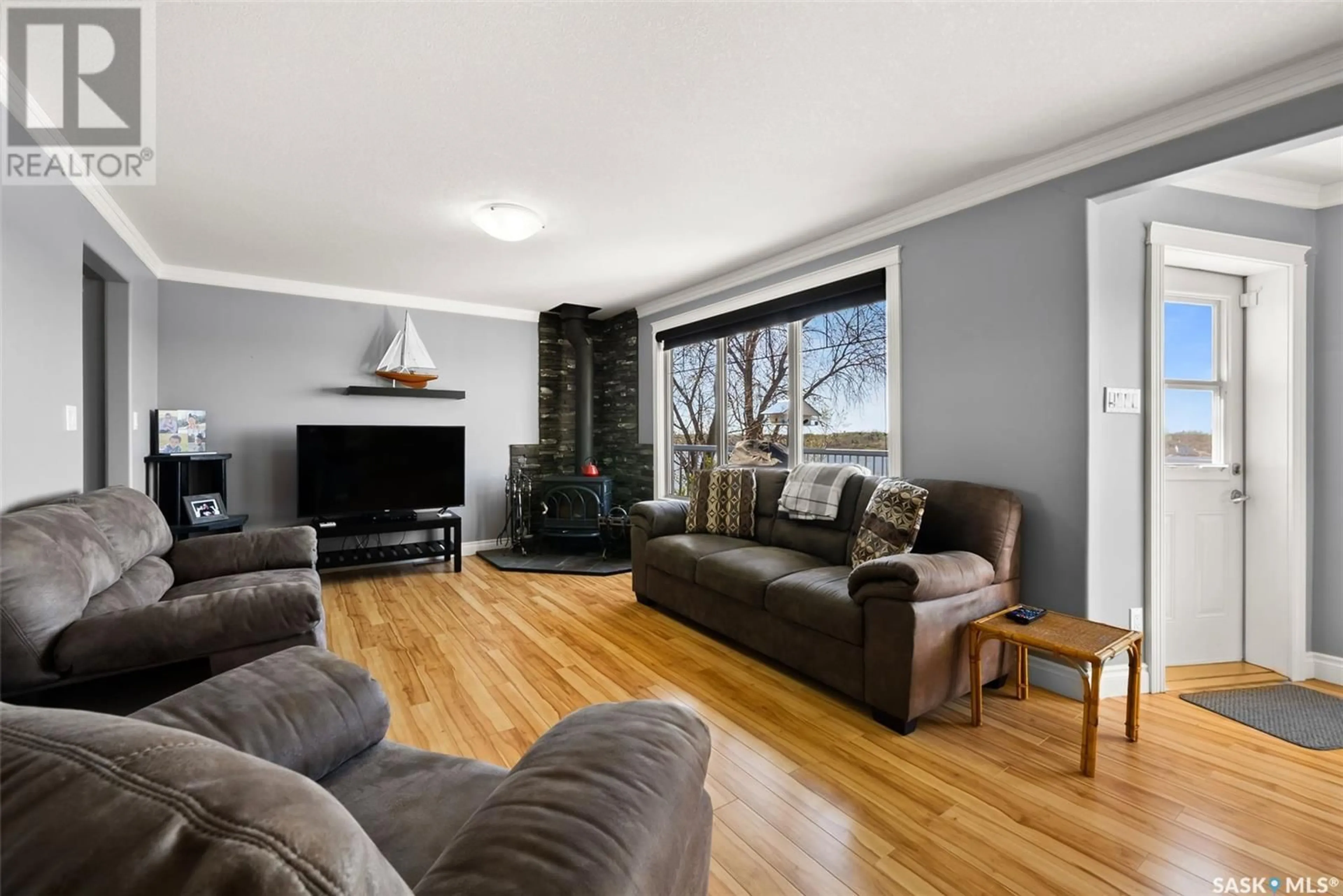 Living room with furniture, wood/laminate floor for 224 PICKEREL STREET, Mckillop Rm No. 220 Saskatchewan S0G4L0