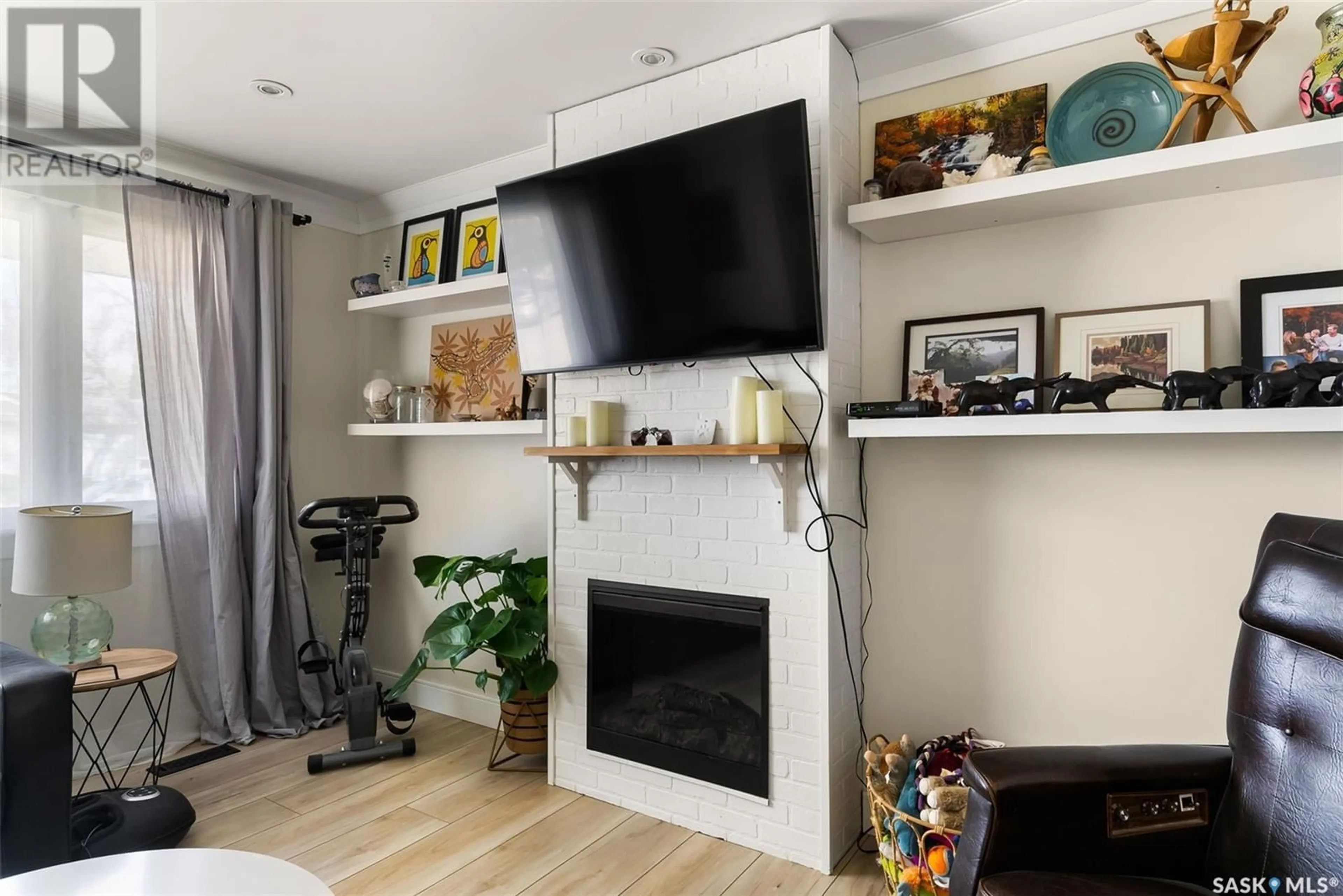 Living room with furniture, wood/laminate floor for 83 NORWOOD CRESCENT, Regina Saskatchewan S4R0A2