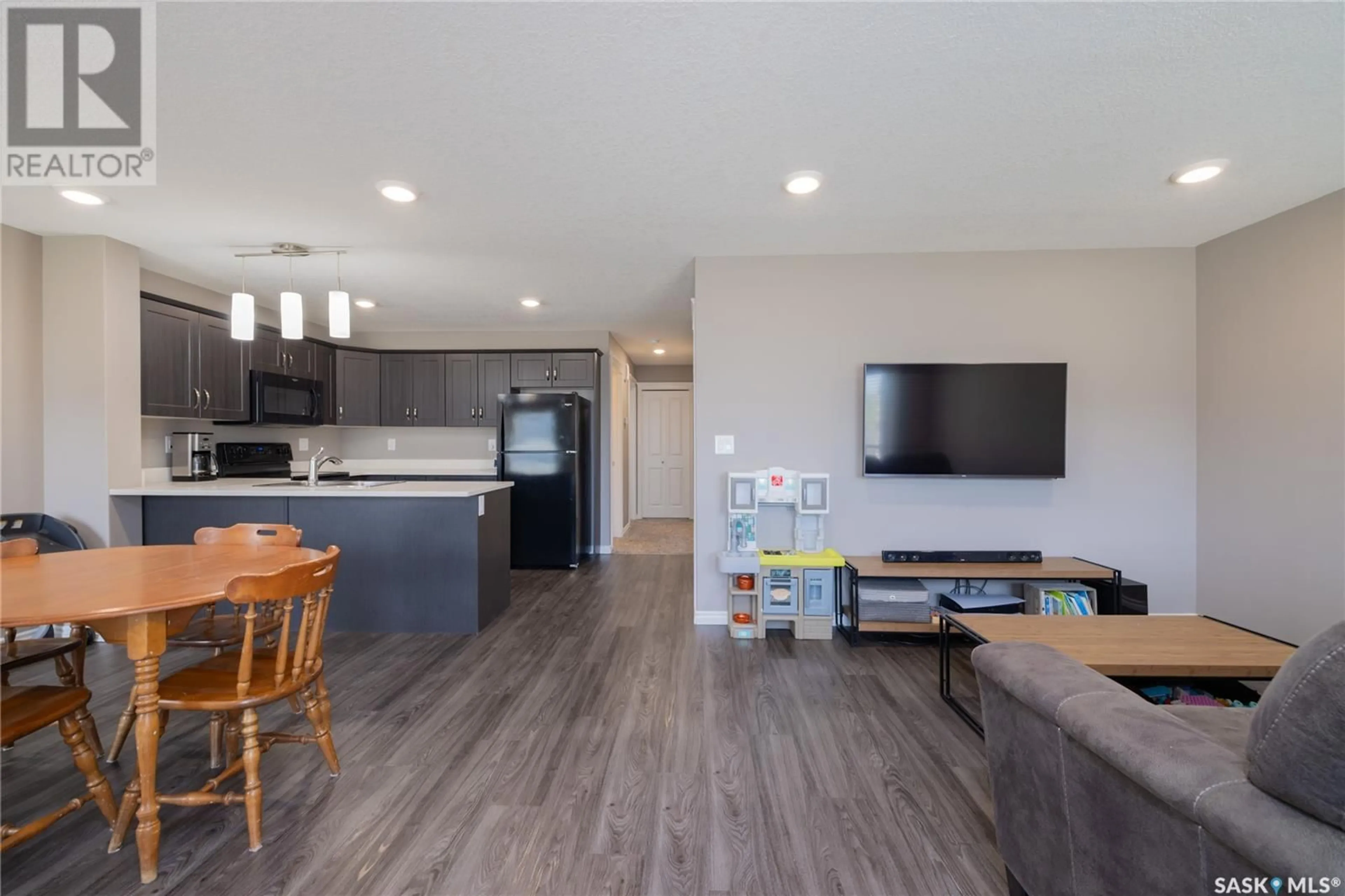 Open concept kitchen, wood/laminate floor for 110 - 104 AKHTAR BEND, Saskatoon Saskatchewan S7W0Y9