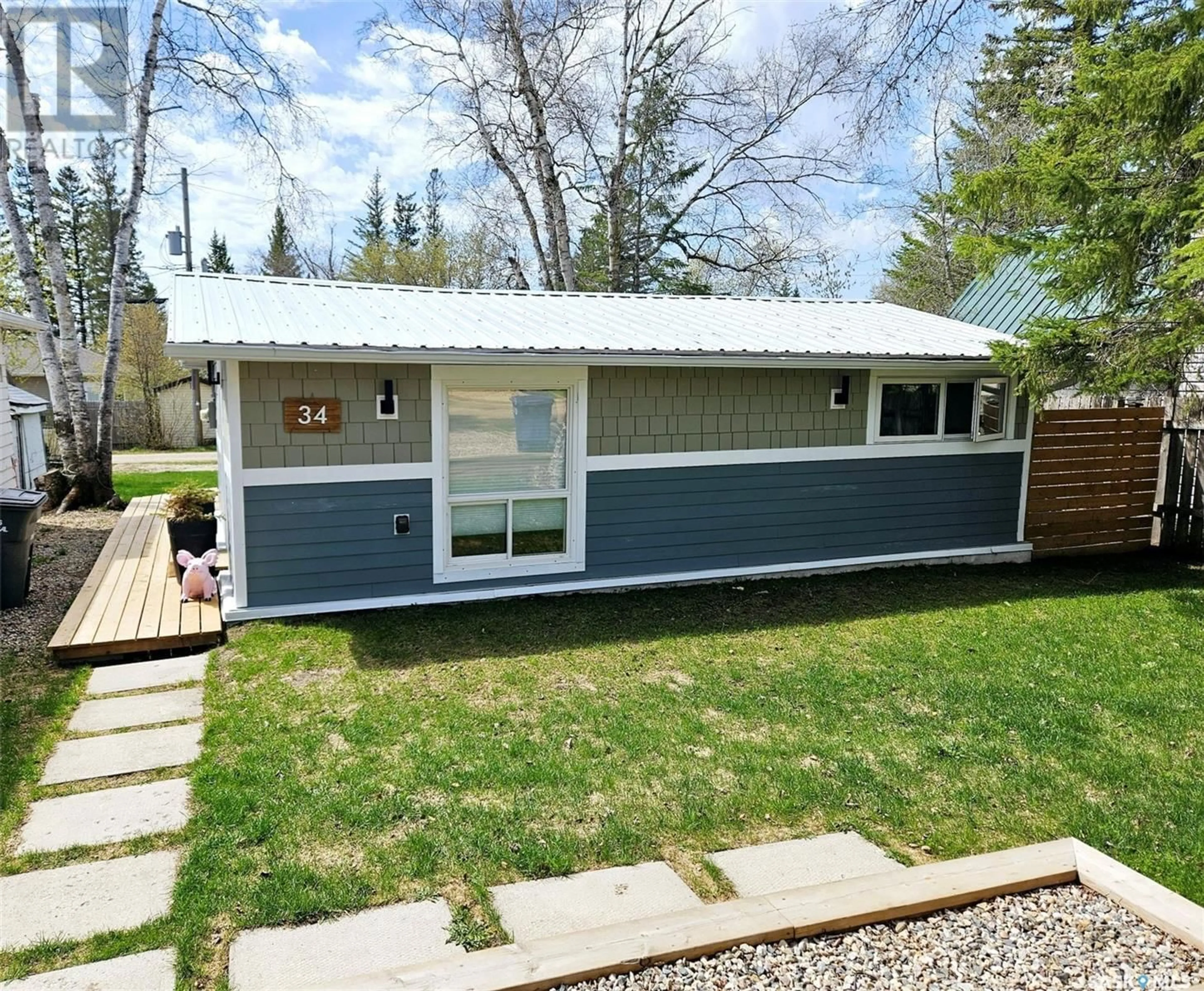 Home with vinyl exterior material, street for 34 OKADOCA STREET, Kenosee Lake Saskatchewan S0C2S0