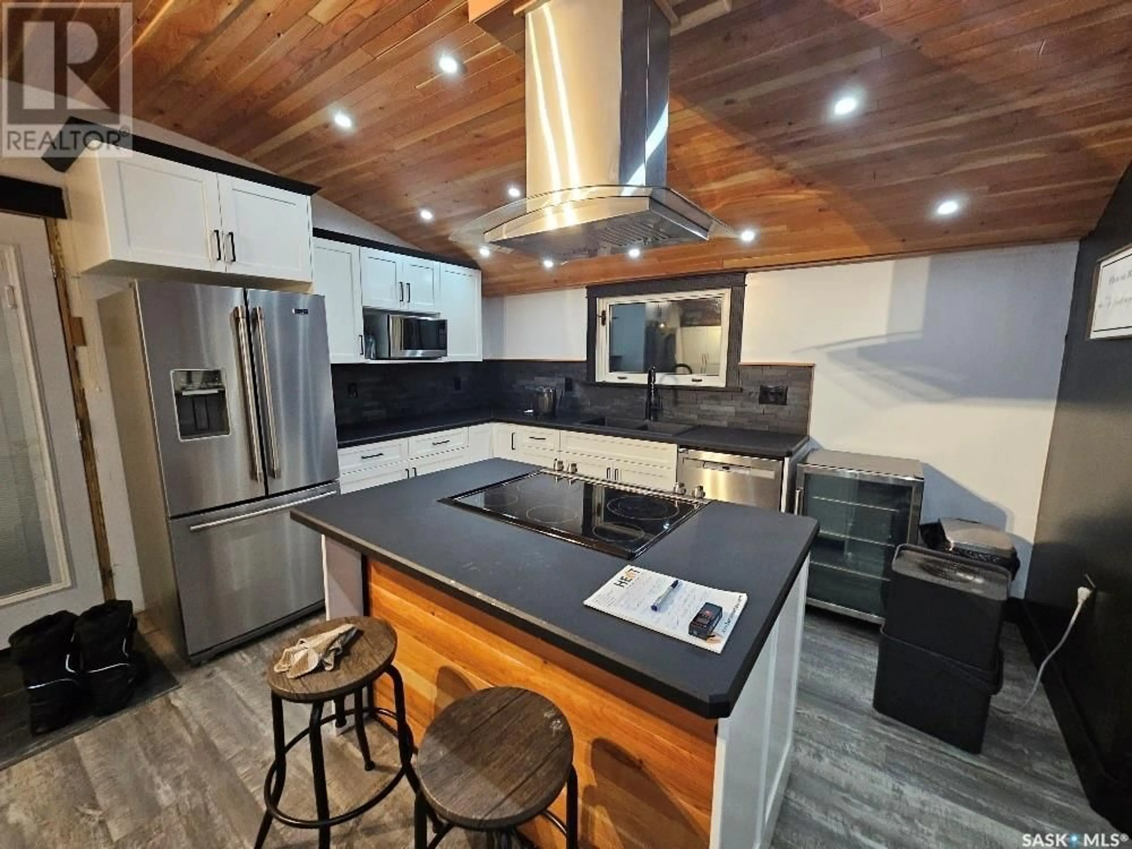 Open concept kitchen, wood/laminate floor for 34 OKADOCA STREET, Kenosee Lake Saskatchewan S0C2S0