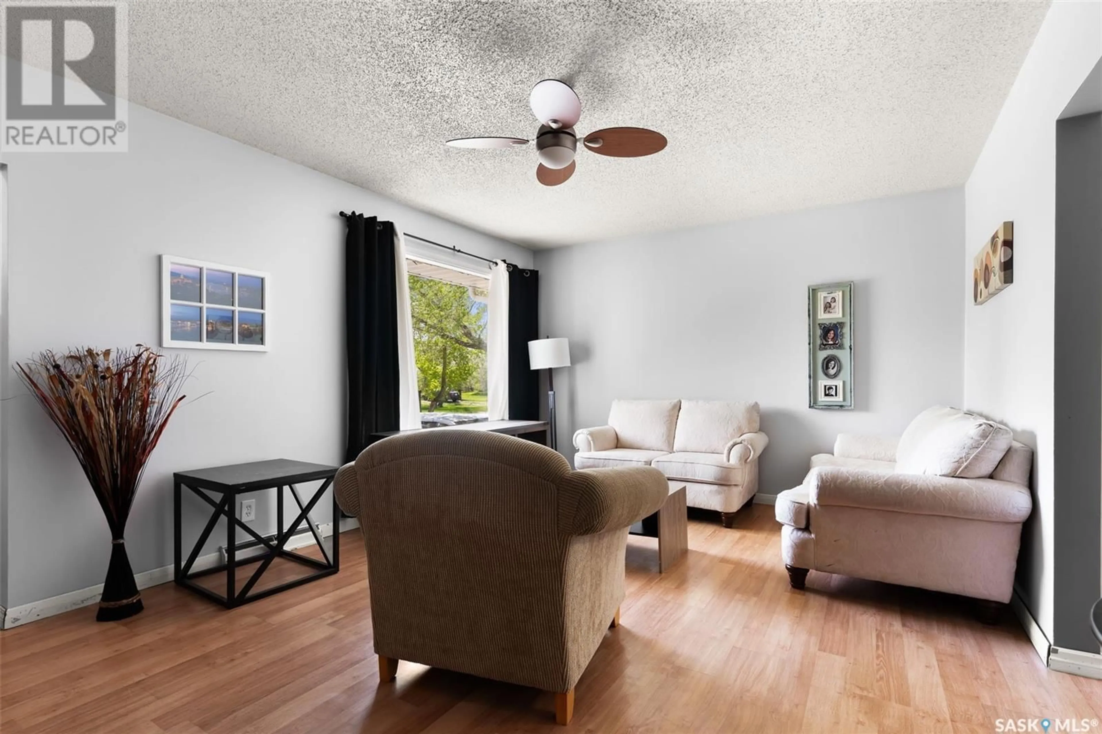 Living room with furniture, wood/laminate floor for 127 QUEEN STREET, Milestone Saskatchewan S0G3L0
