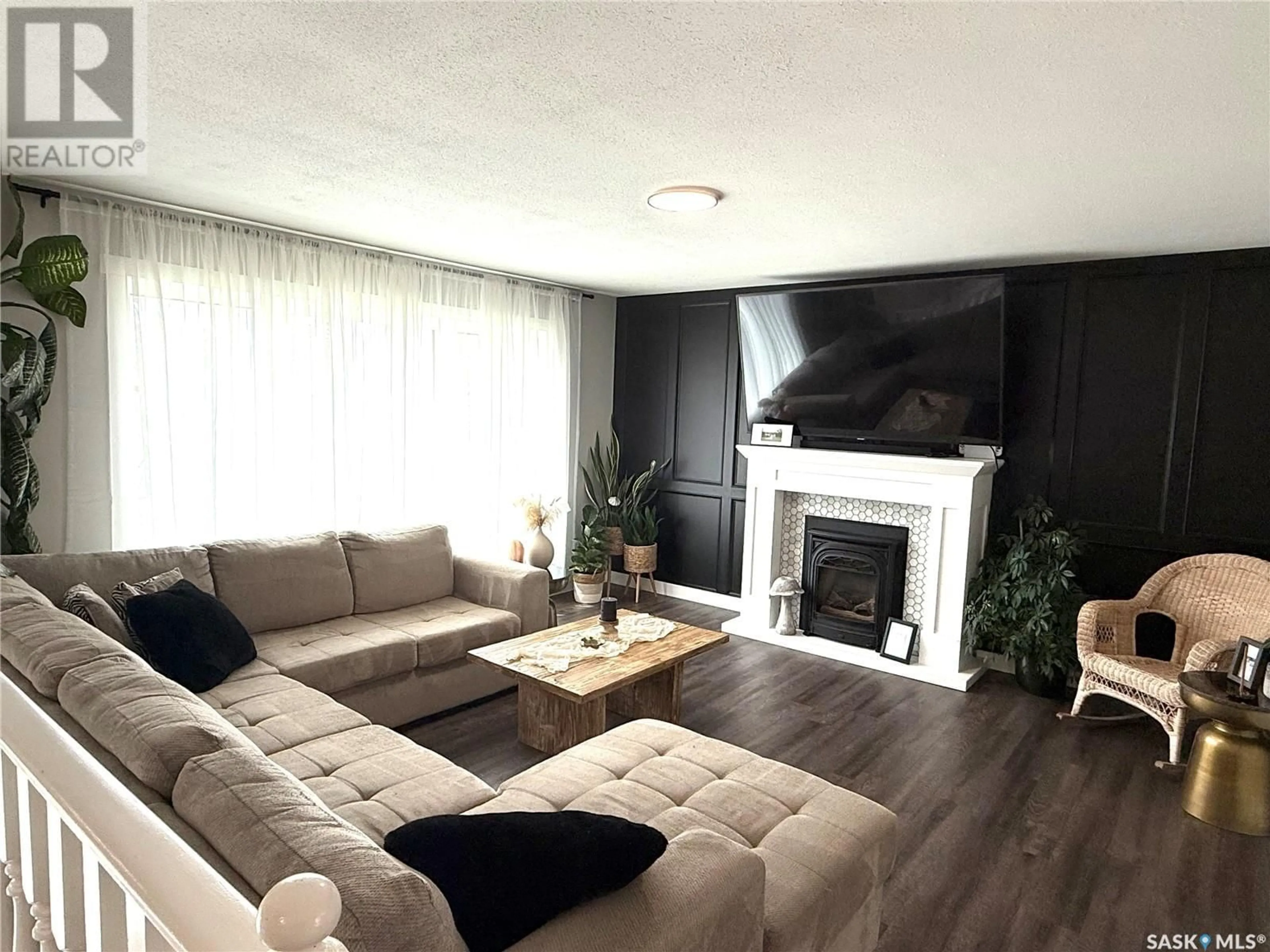 Living room with furniture, wood/laminate floor for 301 NEUFELD AVENUE, Nipawin Saskatchewan S0E1E0