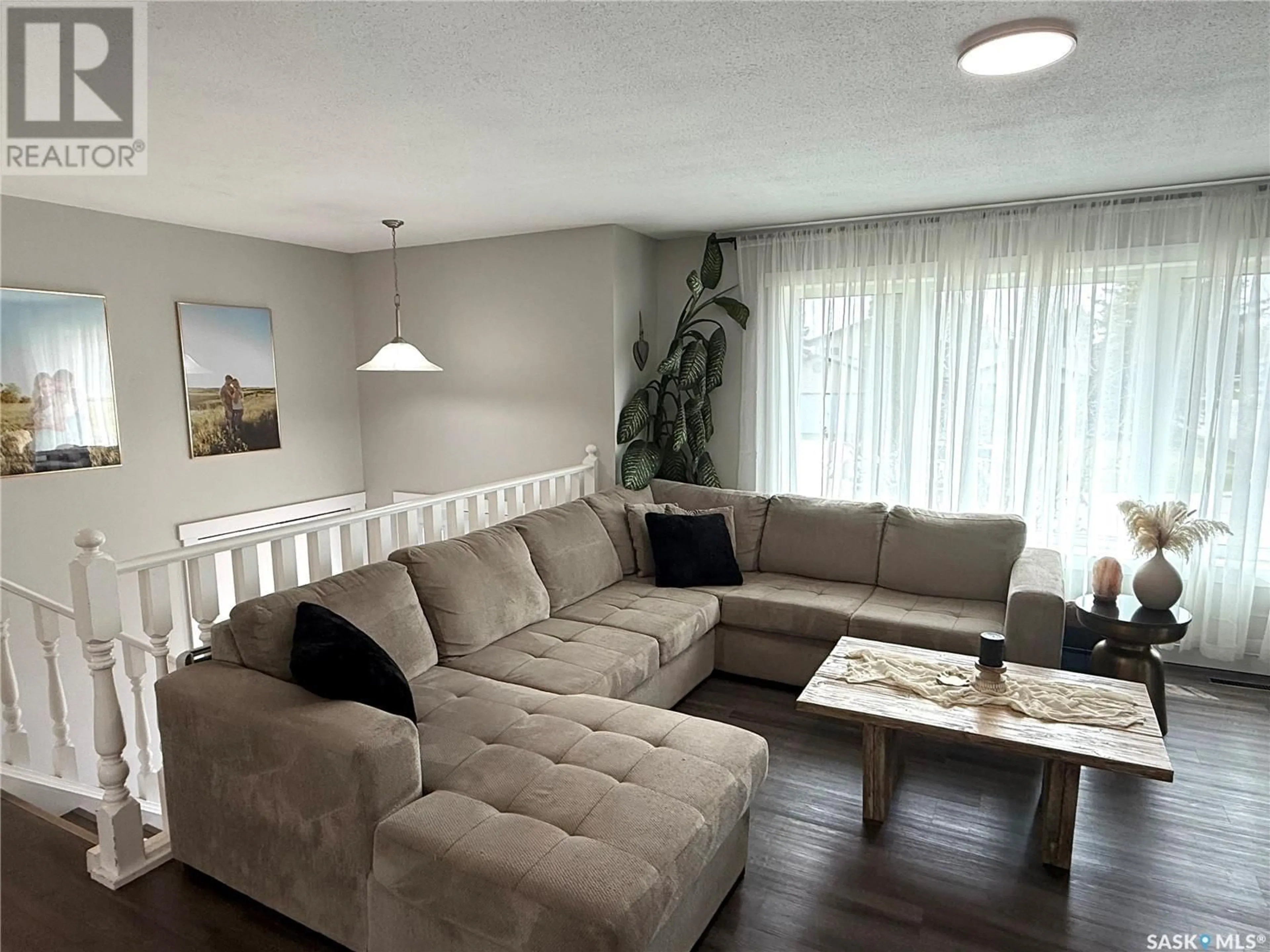 Living room with furniture, wood/laminate floor for 301 NEUFELD AVENUE, Nipawin Saskatchewan S0E1E0
