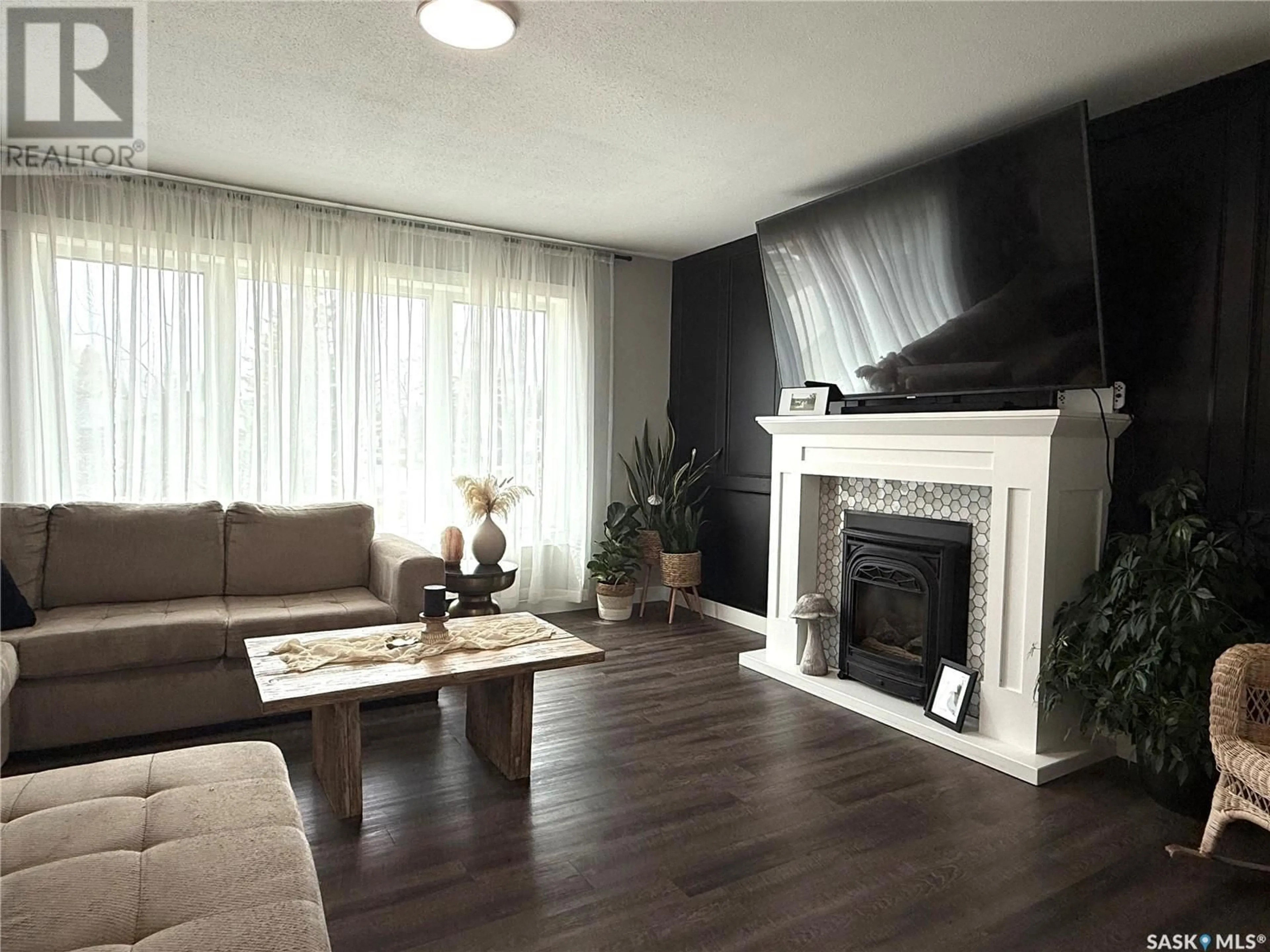 Living room with furniture, wood/laminate floor for 301 NEUFELD AVENUE, Nipawin Saskatchewan S0E1E0