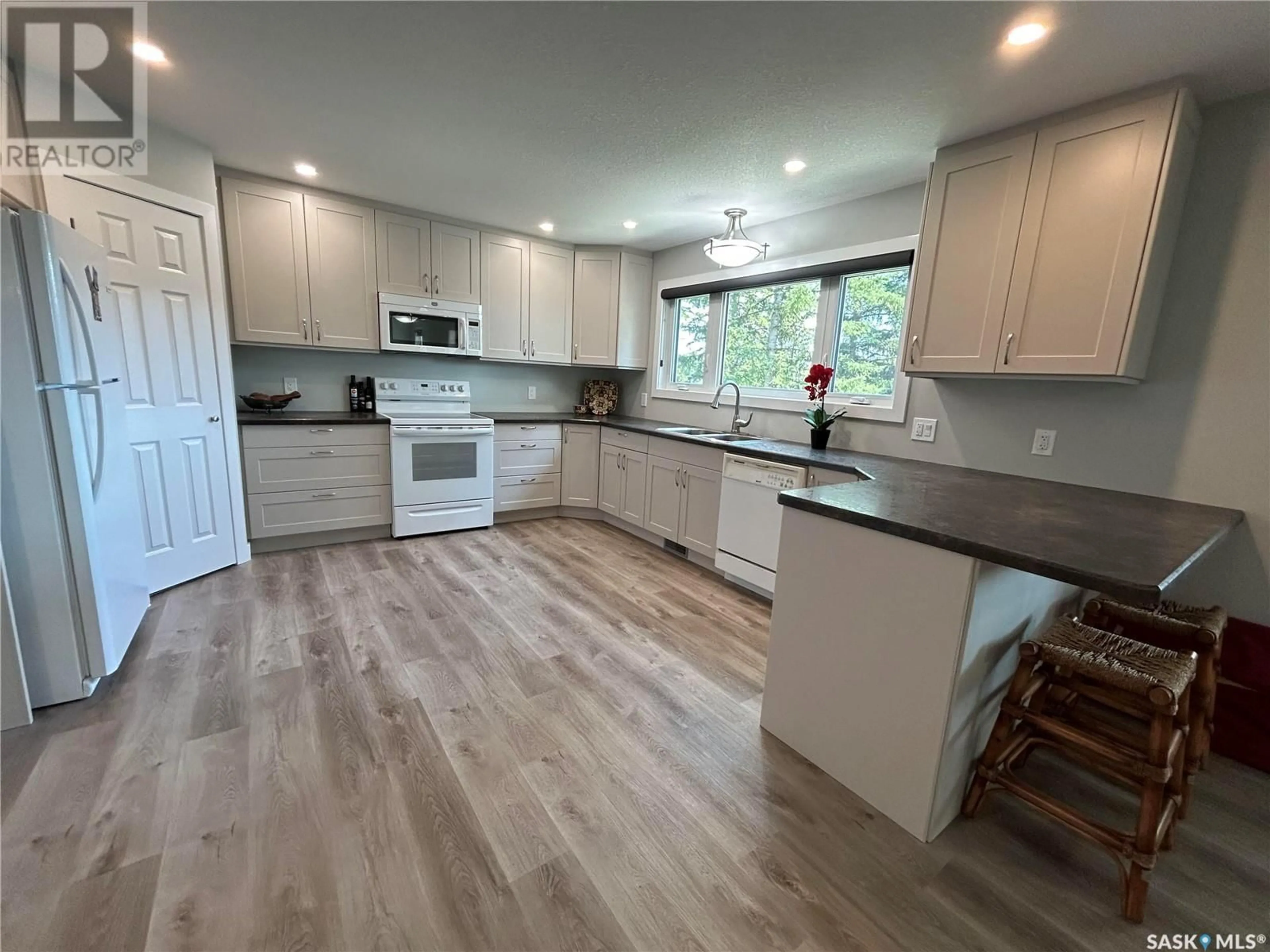 Open concept kitchen, wood/laminate floor for 209 BEN NEVIS DRIVE, Cypress Hills Provincial Park Saskatchewan S0N1N0