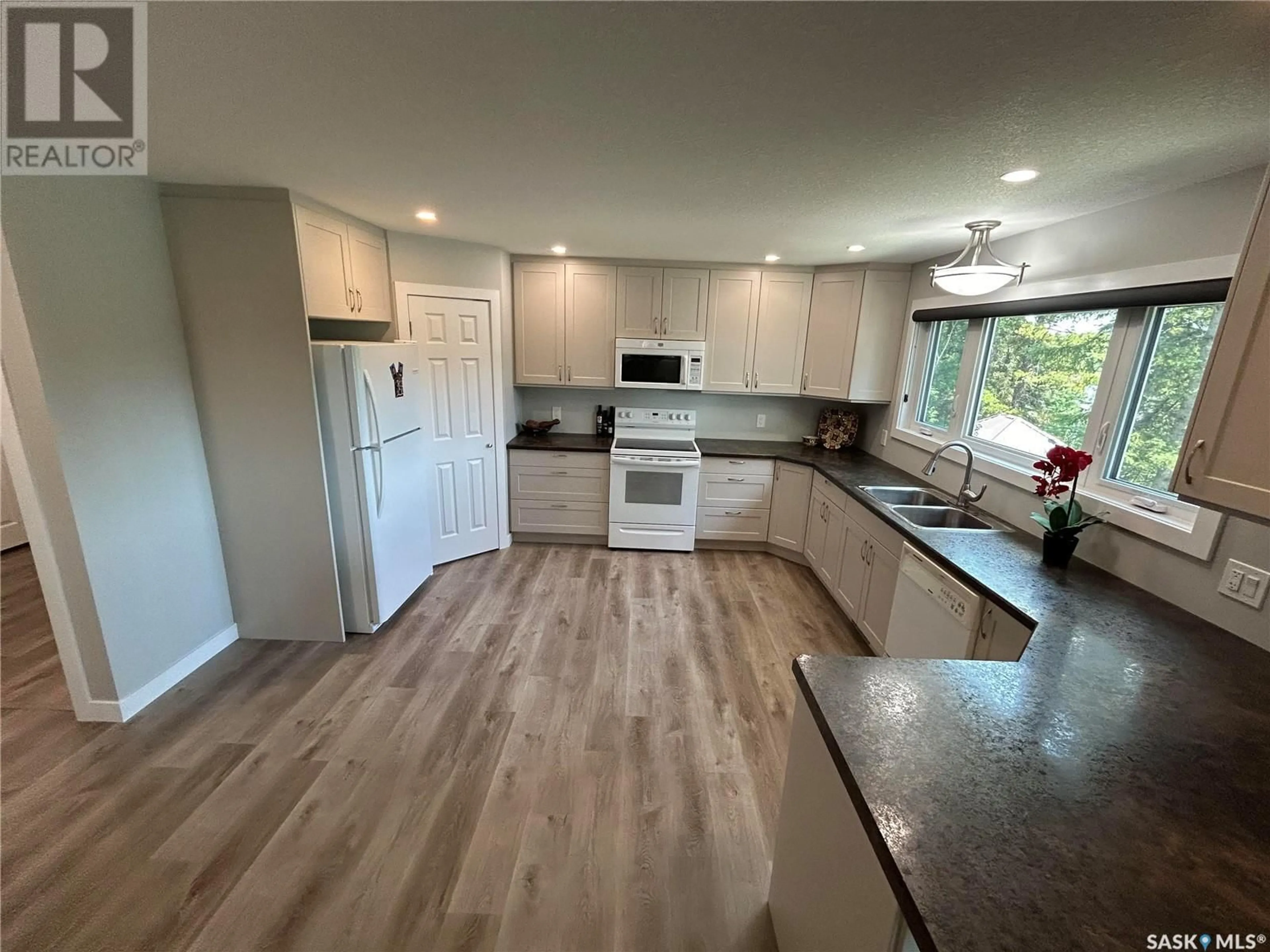 Open concept kitchen, wood/laminate floor for 209 BEN NEVIS DRIVE, Cypress Hills Provincial Park Saskatchewan S0N1N0