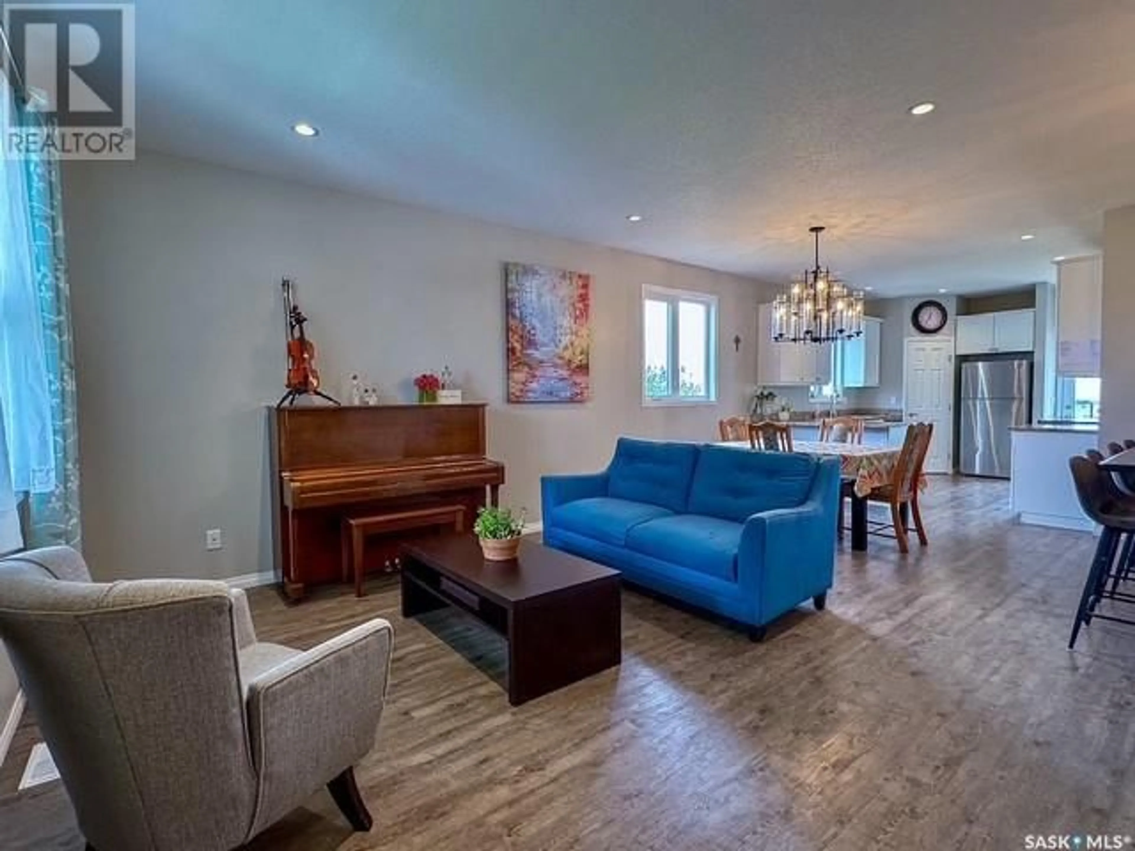 Living room with furniture, wood/laminate floor for NE - 23 9TH AVENUE, Swift Current Saskatchewan S9H2R9