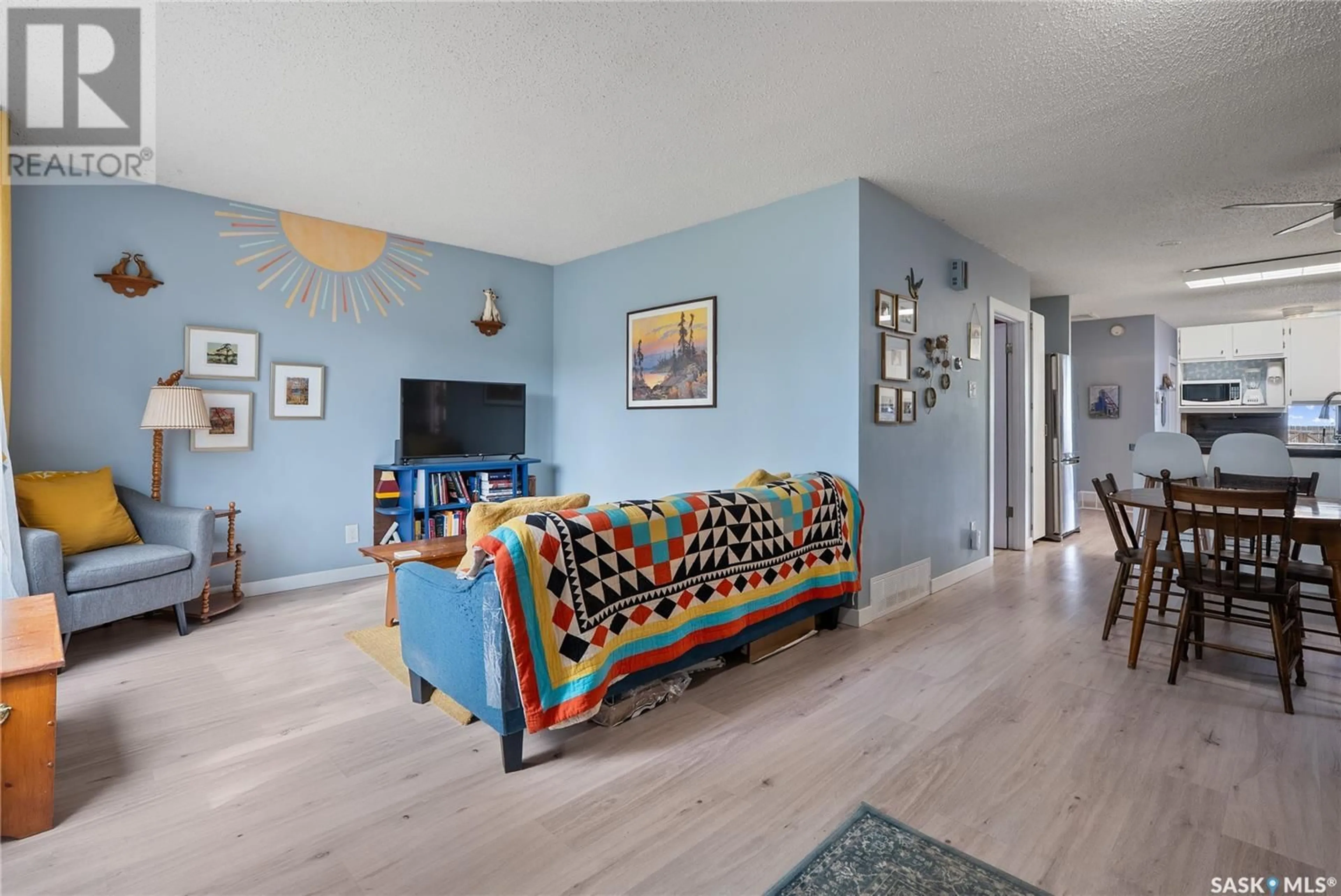Living room with furniture, wood/laminate floor for 720 I AVENUE, Saskatoon Saskatchewan S7M1Y9