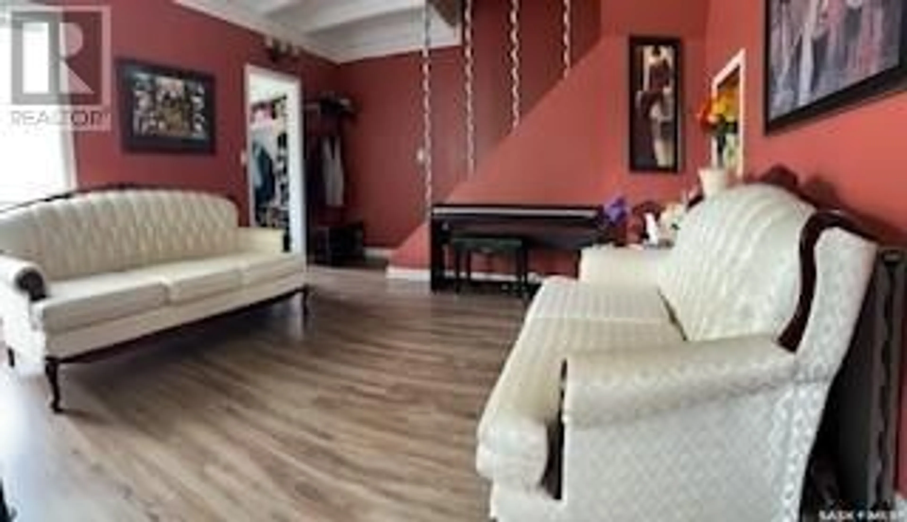 Living room with furniture, wood/laminate floor for 1217 2ND STREET, Estevan Saskatchewan S4A0M1