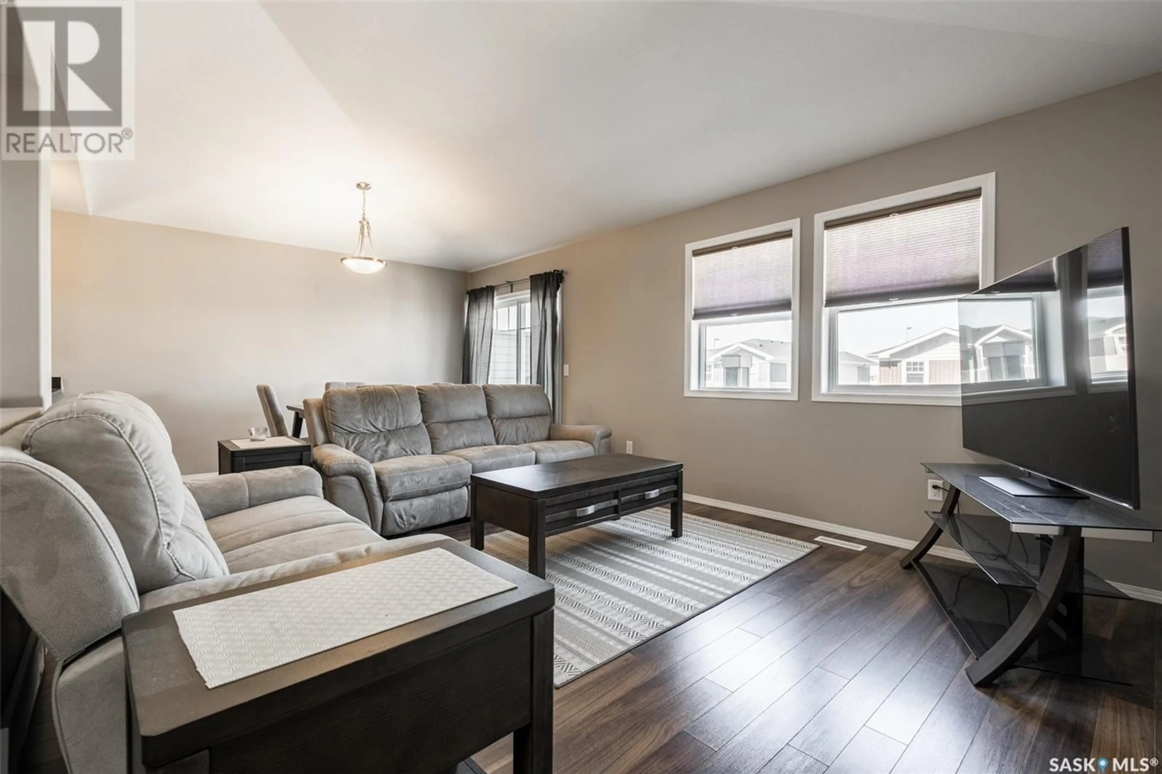 Living room with furniture, wood/laminate floor for 100 - 215 CHAPARRAL BOULEVARD, Martensville Saskatchewan S0K2T2