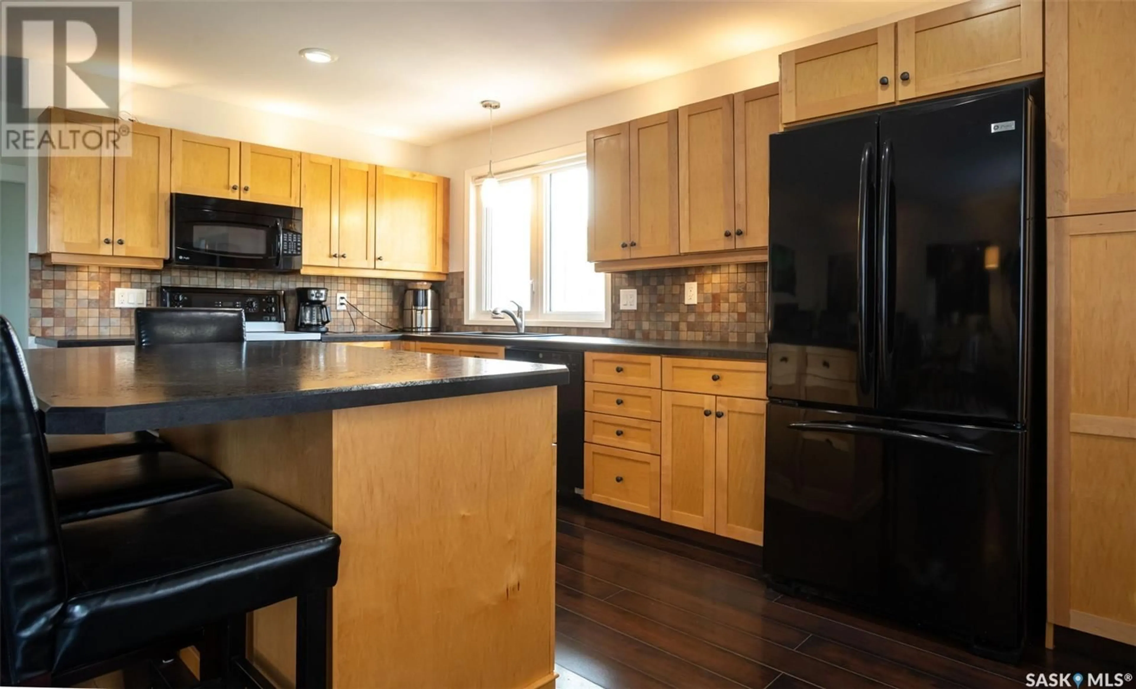 Open concept kitchen, wood/laminate floor for 1108 97TH STREET, Tisdale Saskatchewan S0E1T0