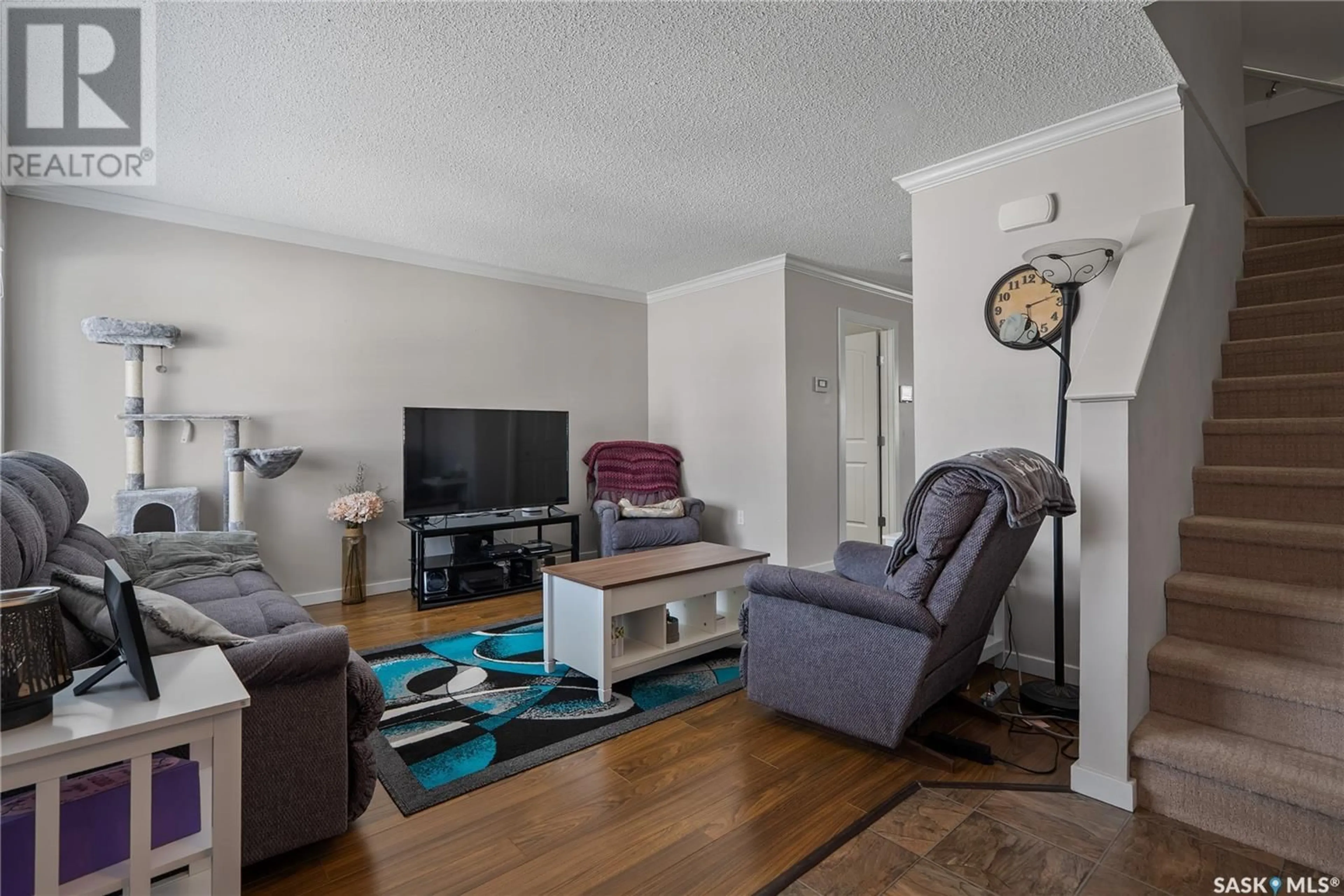 Living room with furniture, wood/laminate floor for 207 - 21 MCCALLUM WAY, Saskatoon Saskatchewan S7R0K6
