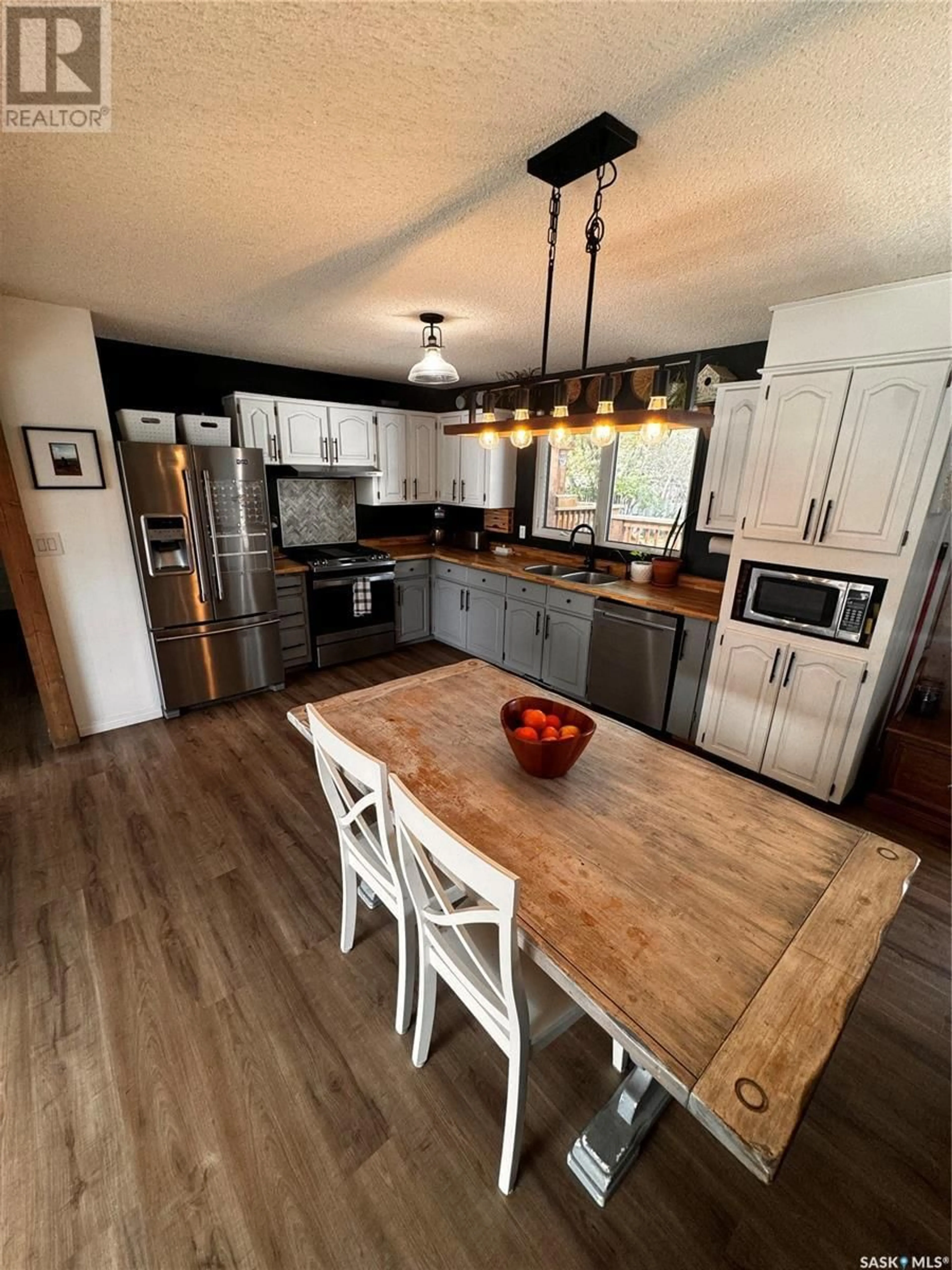 Open concept kitchen, wood/laminate floor for 224 17TH STREET, Weyburn Saskatchewan S4H2P2