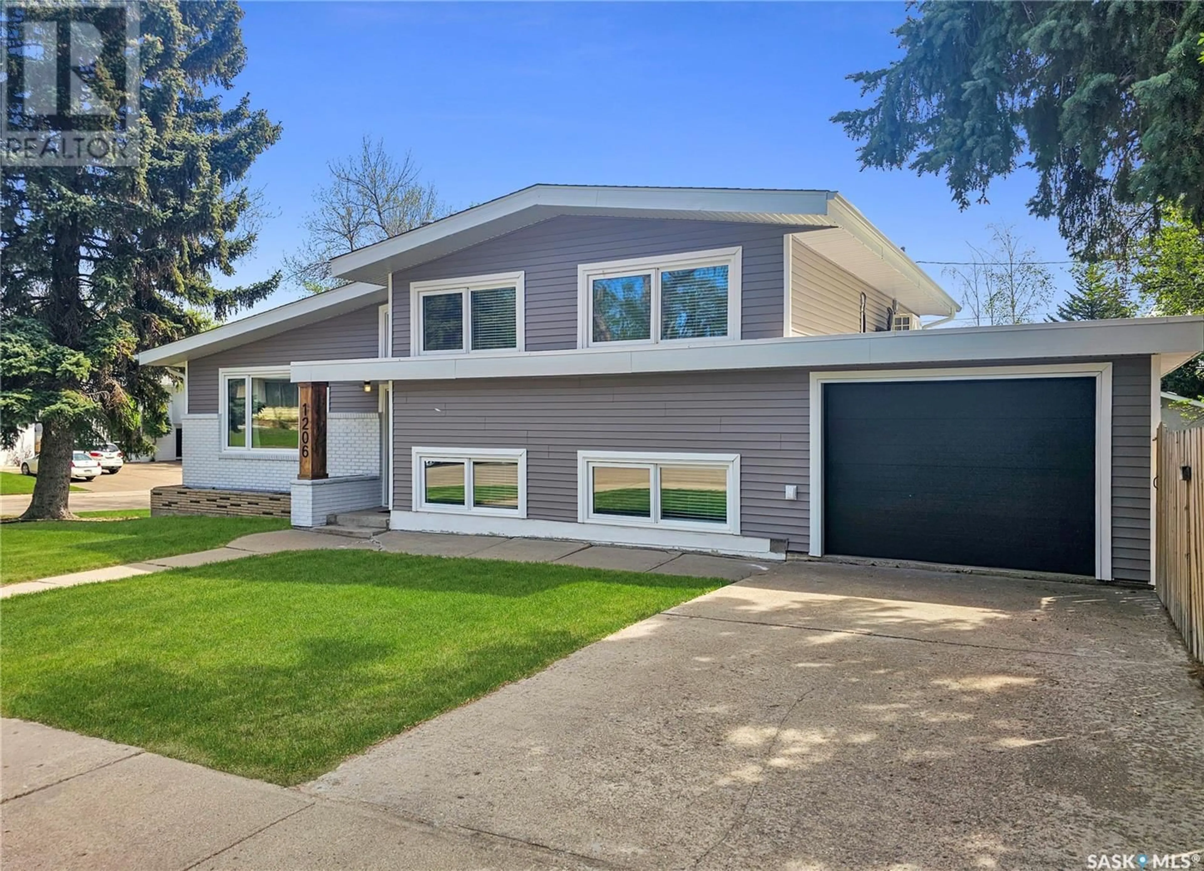 Home with vinyl exterior material, street for 1206 IRWIN DRIVE, Swift Current Saskatchewan S9H1Z7
