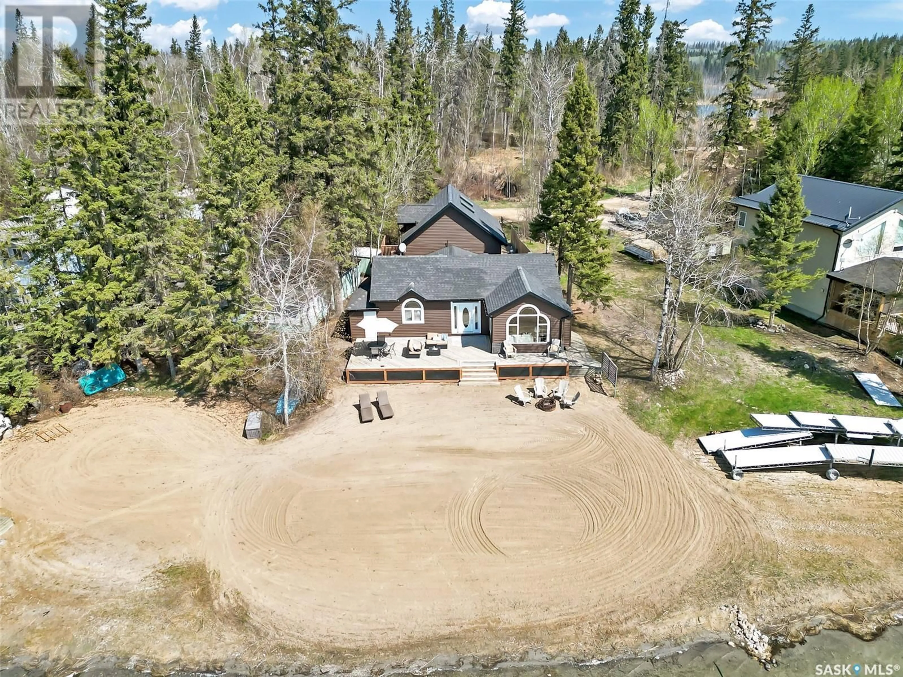 A pic from outside/outdoor area/front of a property/back of a property/a pic from drone, water/lake/river/ocean view for 113 JANICE PLACE, Emma Lake Saskatchewan S0J0N0