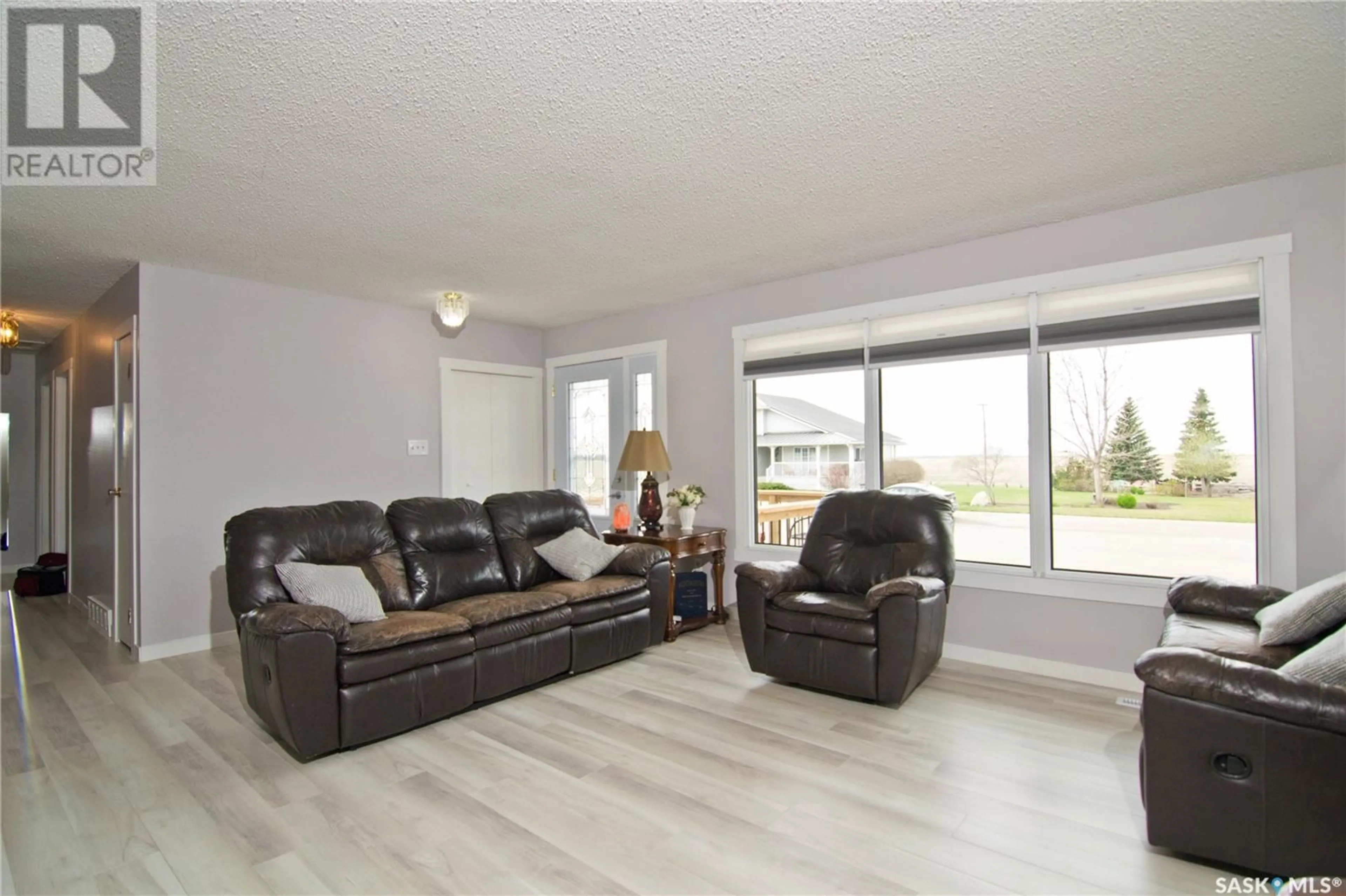 Living room with furniture, wood/laminate floor for 403 2ND AVENUE, Montmartre Rm No. 126 Saskatchewan S0G3M0