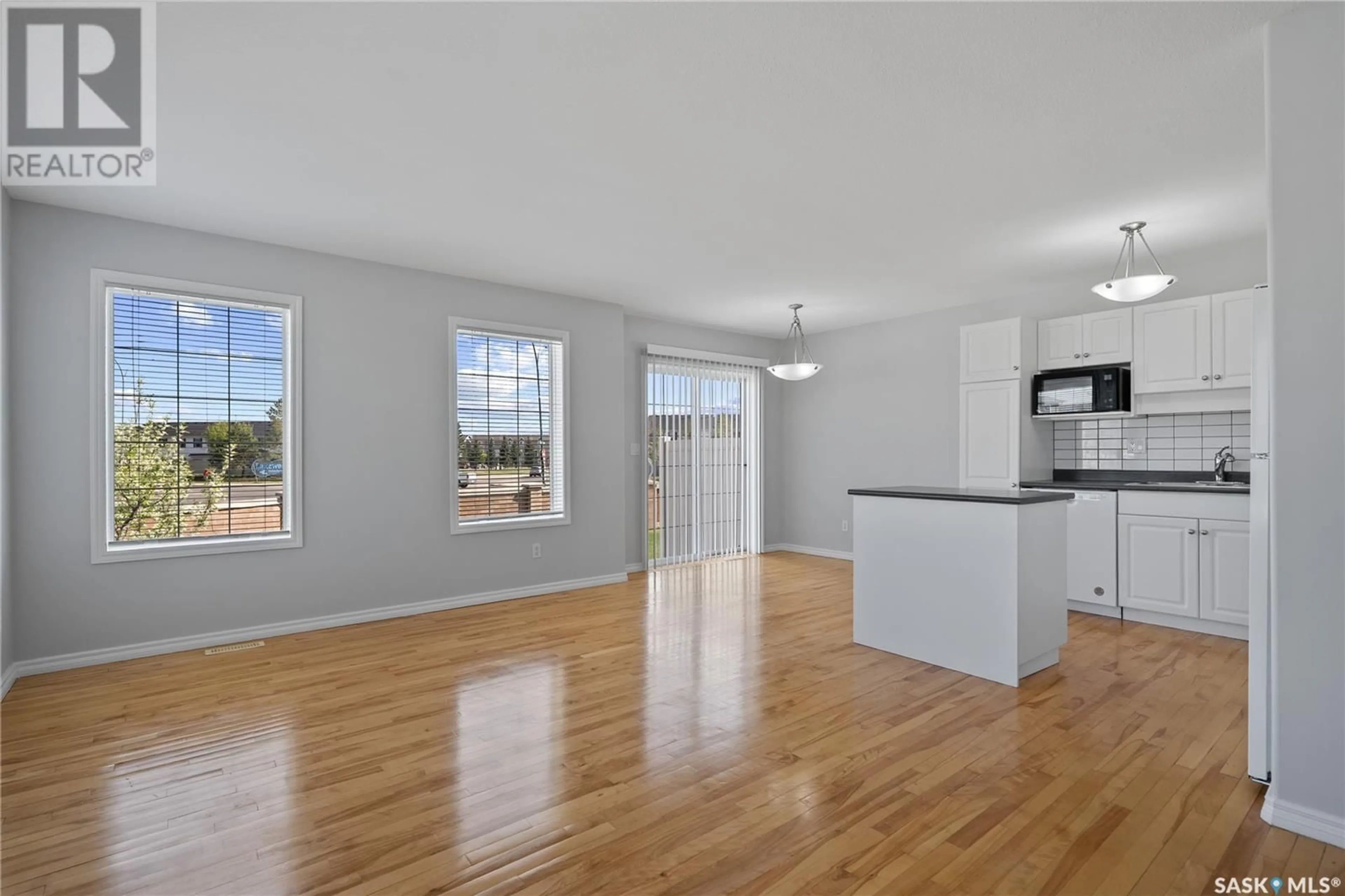 Open concept kitchen, wood/laminate floor for 58 127 BANYAN CRESCENT, Saskatoon Saskatchewan S7V1G5