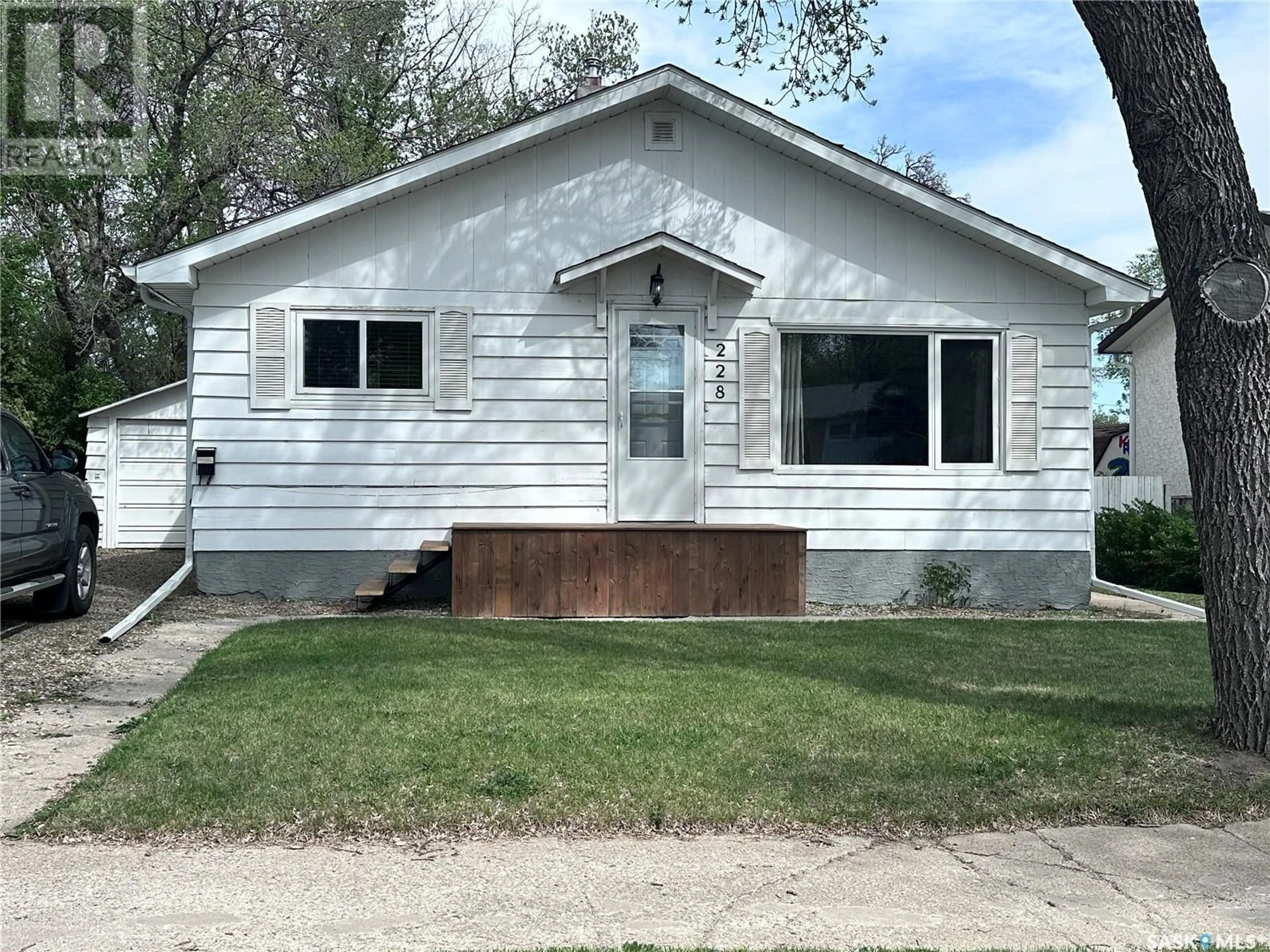 Home with vinyl exterior material, street for 228 LORRAINE STREET, Weyburn Saskatchewan S4H1S1